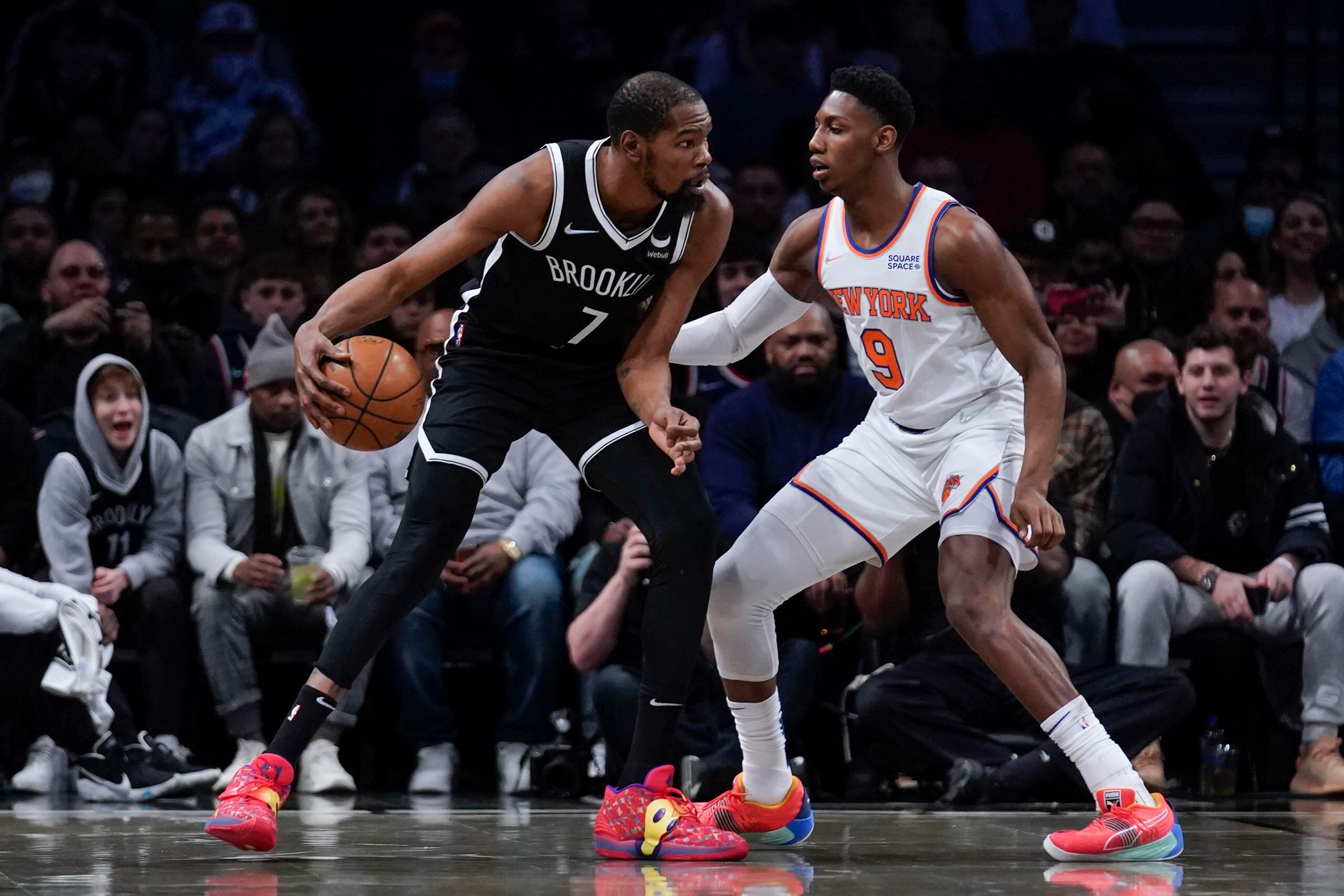 RJ Barrett (derecha) de los Knicks de Nueva York marca a Kevin Durante de los Nets de Brooklyn.