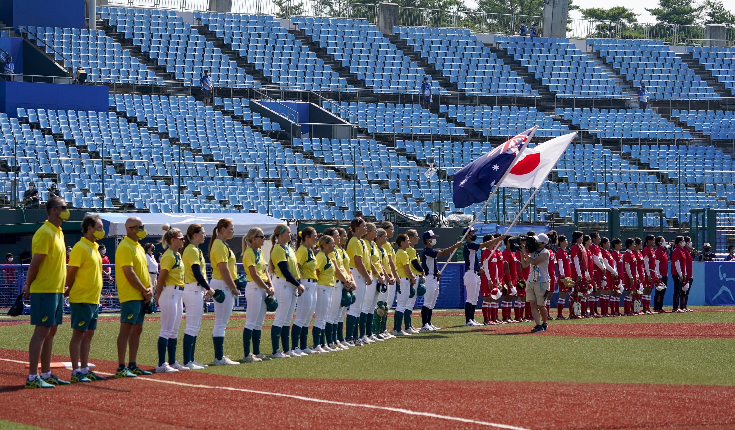 Los equipos de Japón y Australia escuchan los himnos nacionales de sus países antes del inicio del encuentro entre ambos equipos, que inició la acción de Tokio 2020.