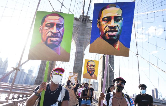 Manifestación en el puente de Brooklyn, Nueva York, en la que personas cargaron imágenes de George Floyd.