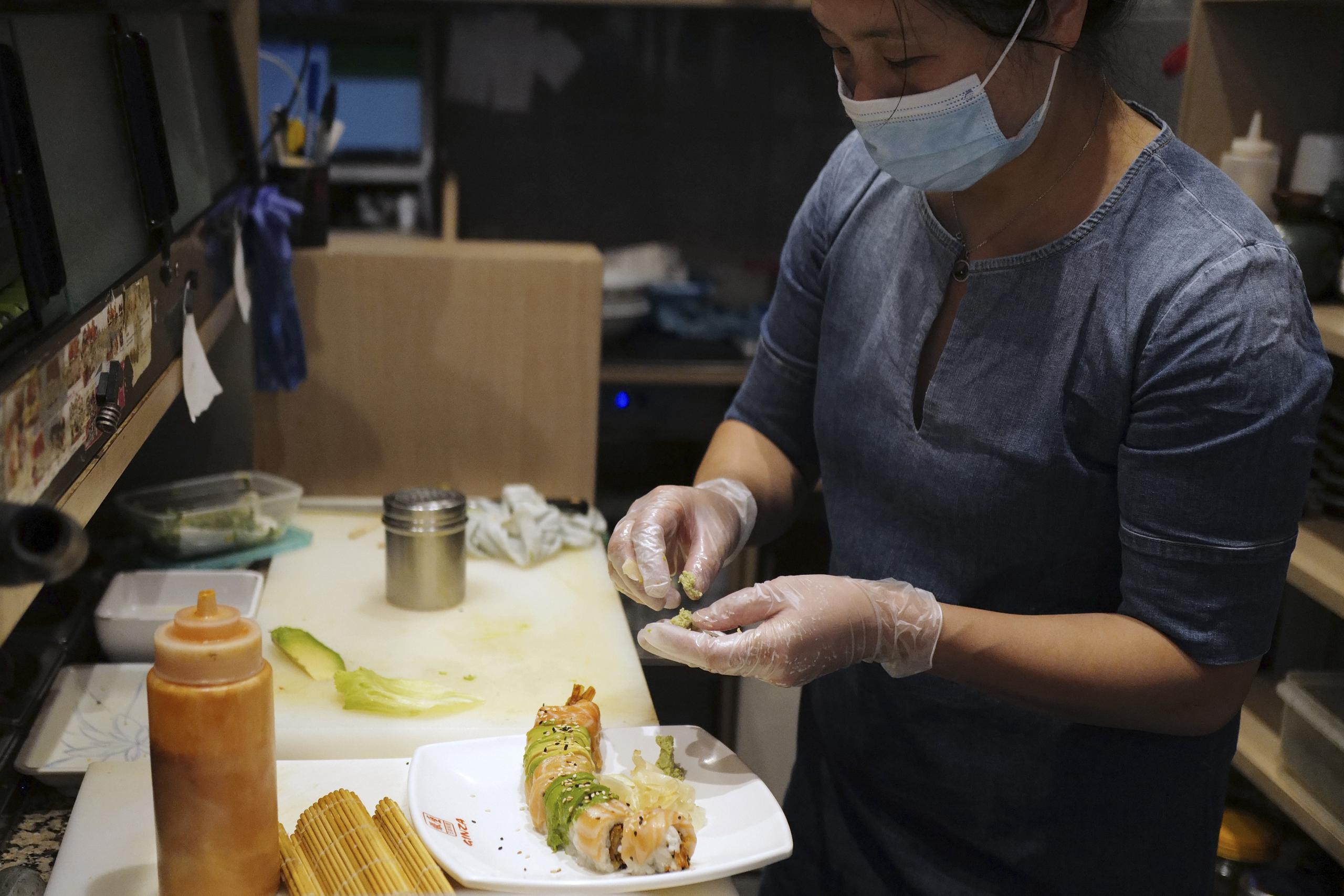 Shao Lin Tia  prepara ssushi en un restaurante de París, Francia, golpeado por la pandemia.