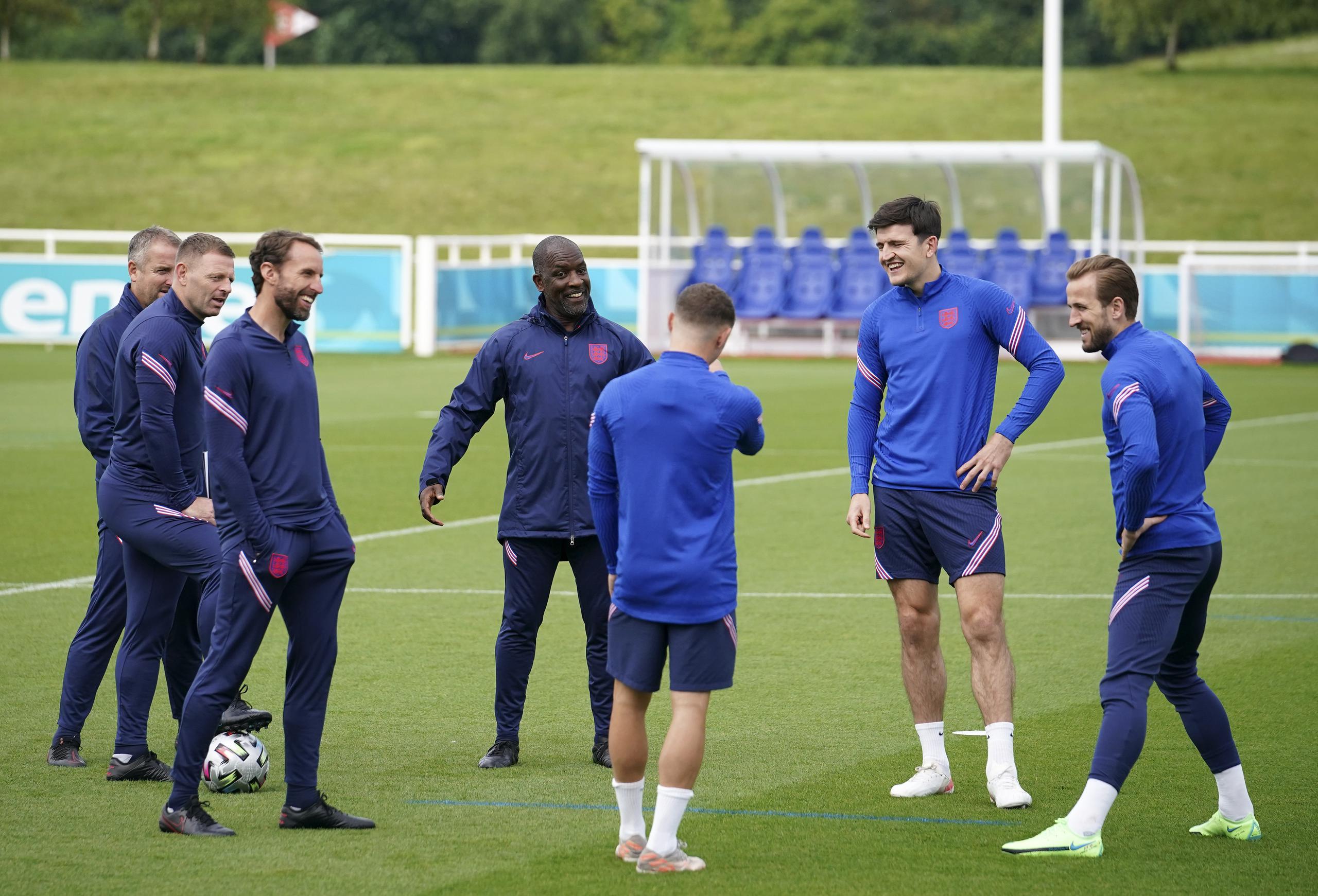 El dirigente de Inglaterra, Gareth Southgate, tercero desde la izquierda, charla con integrantes del seleccionado durante una práctica realizada el sábado, la última antes de la final de la Eurocopa del domingo.