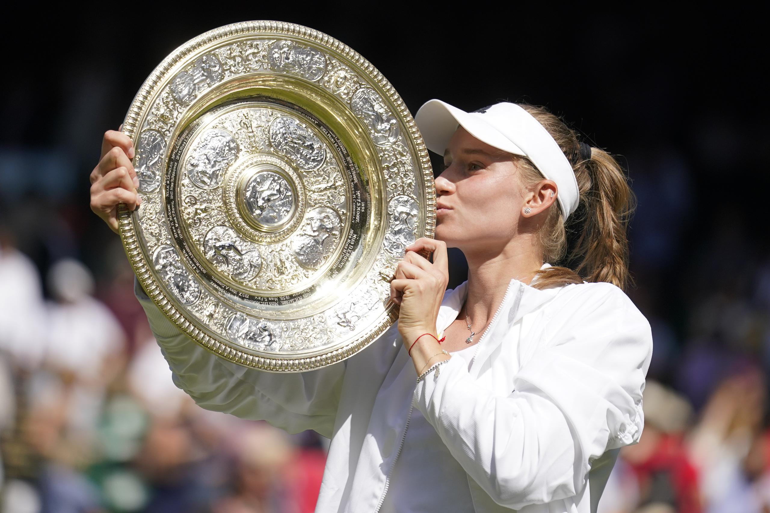 Elena Rybakina besa el trofeo mientras celebra su primer campeonato en Wimbledon.