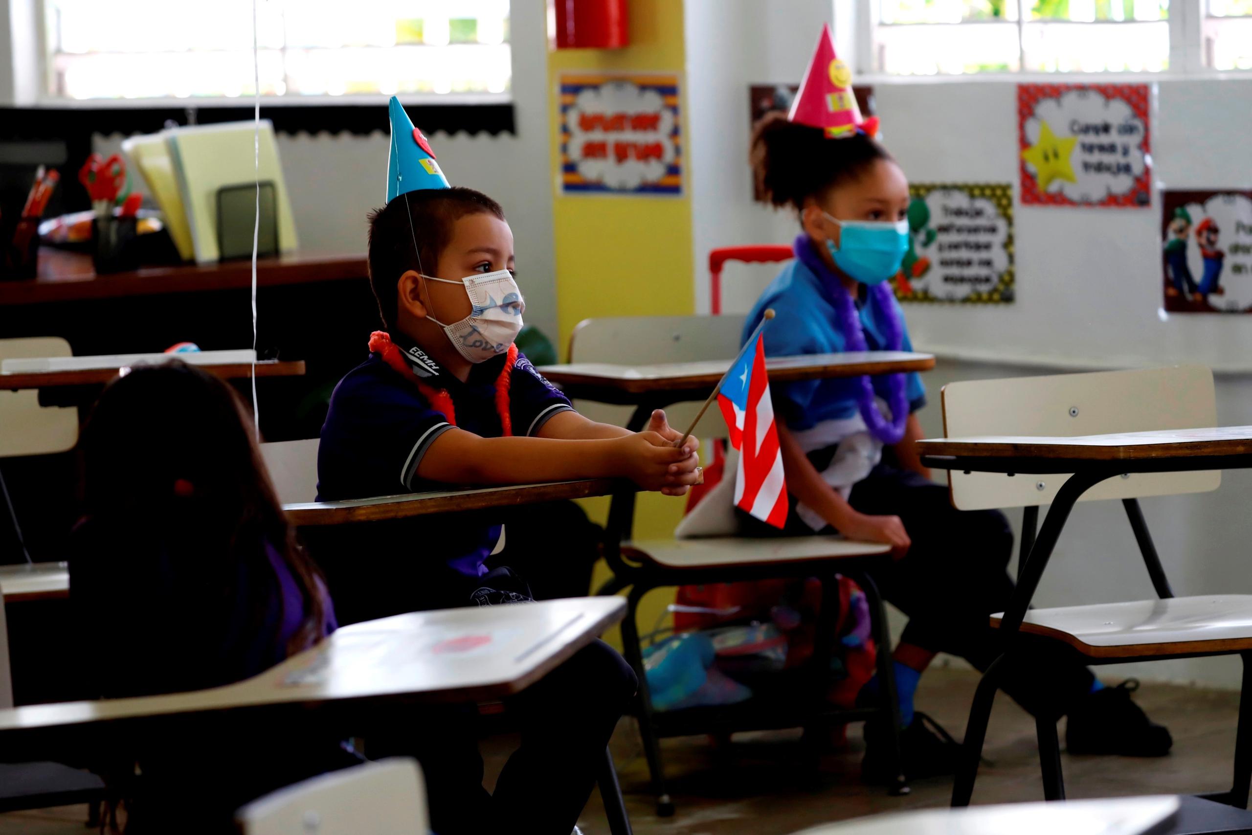 Fotografía de archivo fechada el 10 de abril del 2021 de dos niños durante una clase en la escuela Eugenio María de Hostos en Cayey, en Cayey (Puerto Rico). EFE/ Thais Llorca
