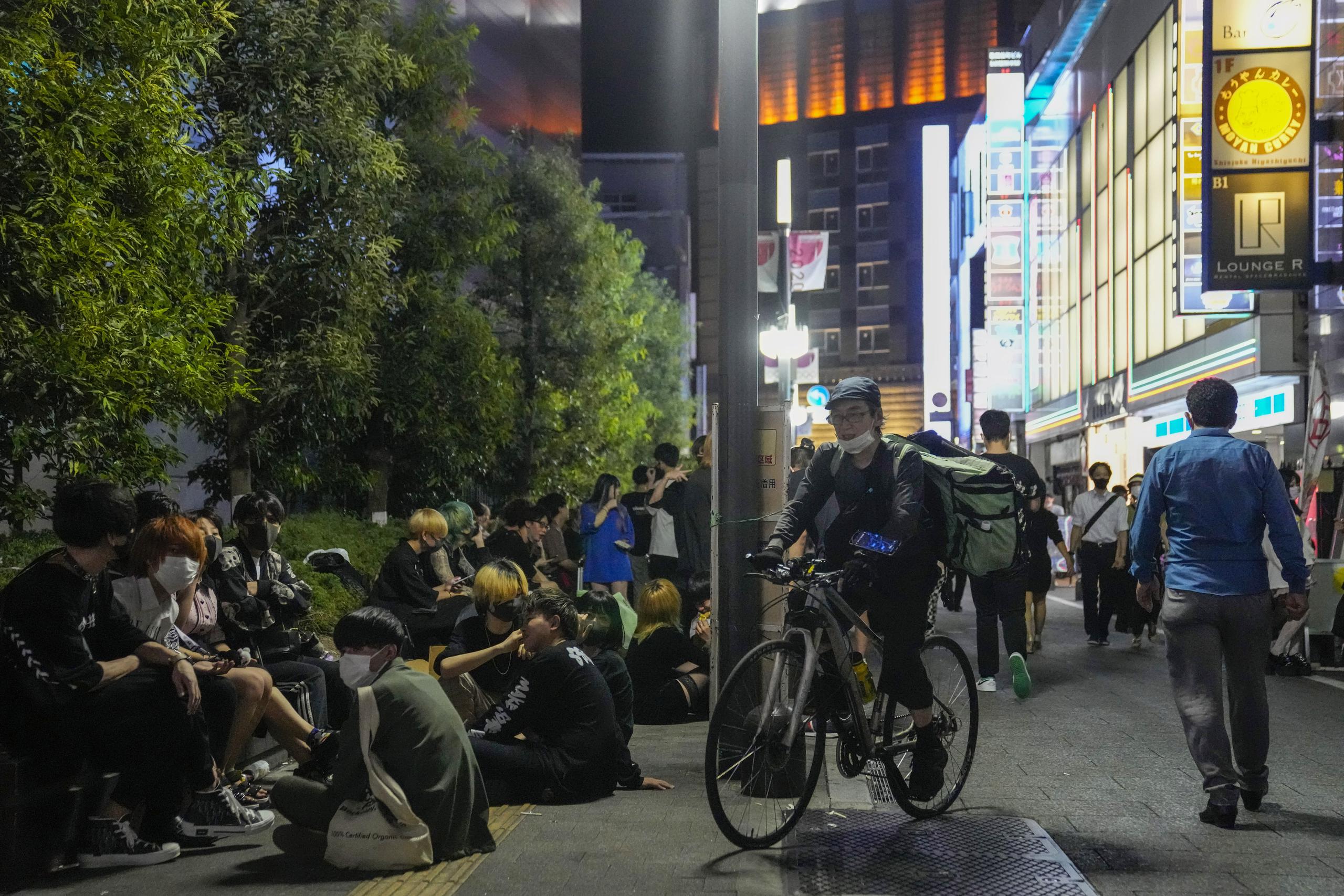 Decenas de personas reunidas frente a un bar de Tokio que sigue vendiendo bebidas alcohólicas después de las ocho de la noche, a pesar de que las autoridades pidieron que dejasen de hacerlo para combatir la propagación del coronavirus durante los Juegos Olímpicos.