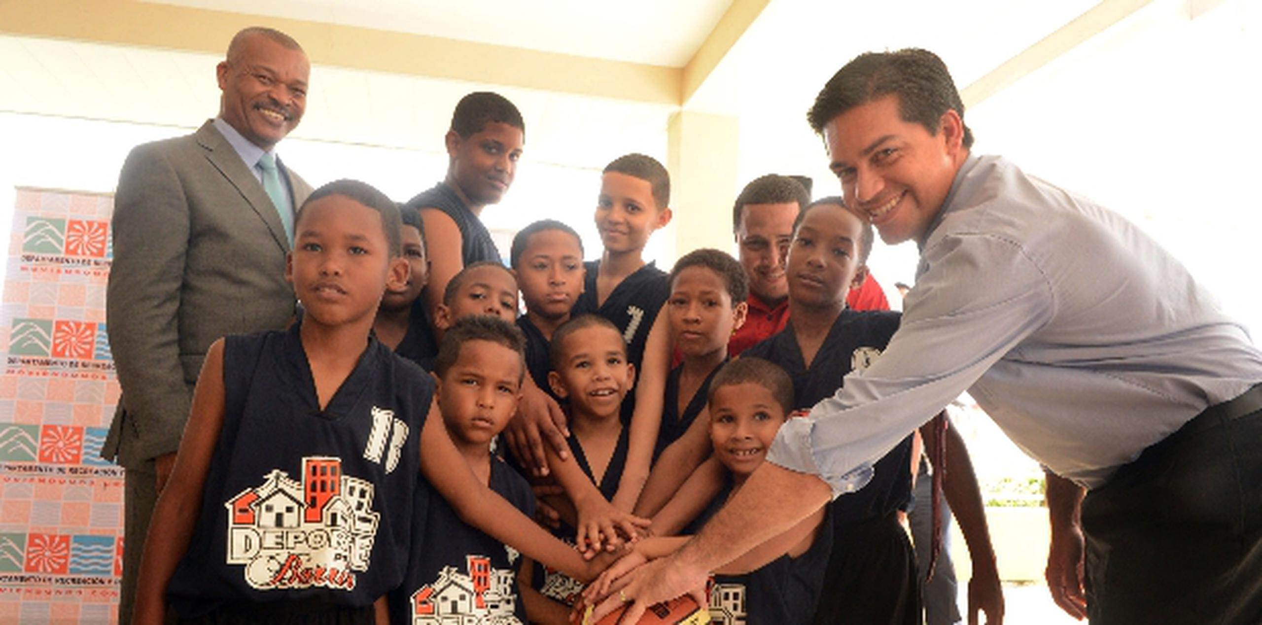 El secretario del DRD Ramón Orta (extrema derecha) posa junto con algunos de los niños que participarán en el programa Deporte pa'l Barrio. Suministrada