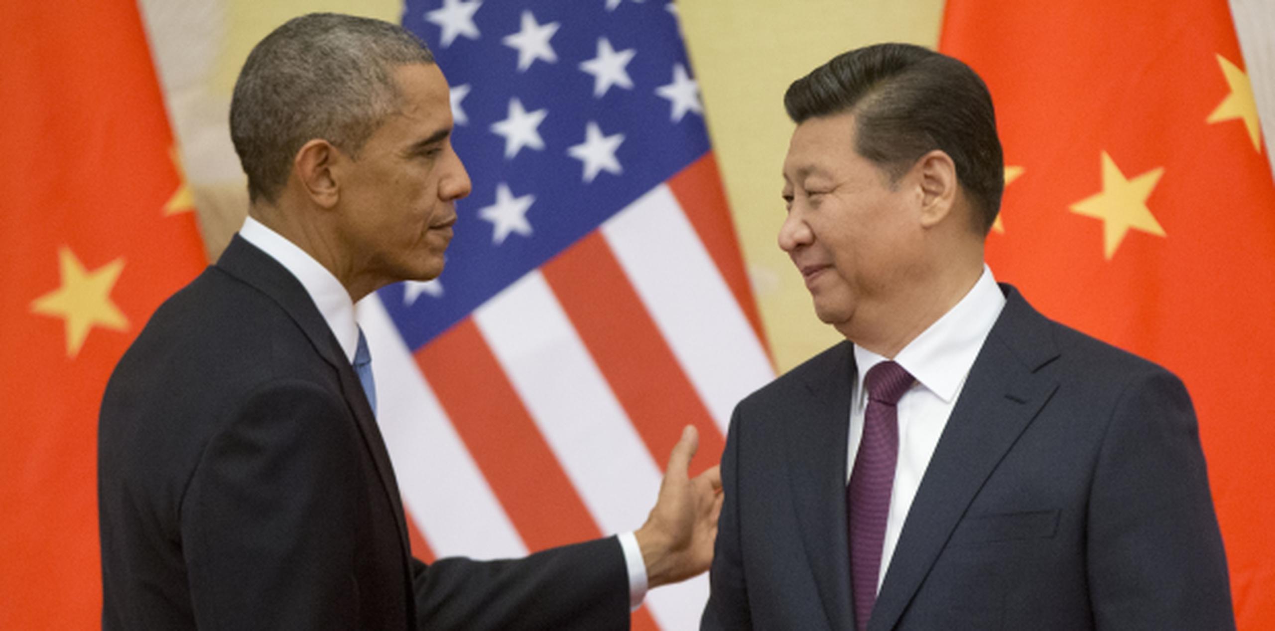 Obama, aquí con el presidente Xi Jinping, visitó a China en el 2014. (AP)