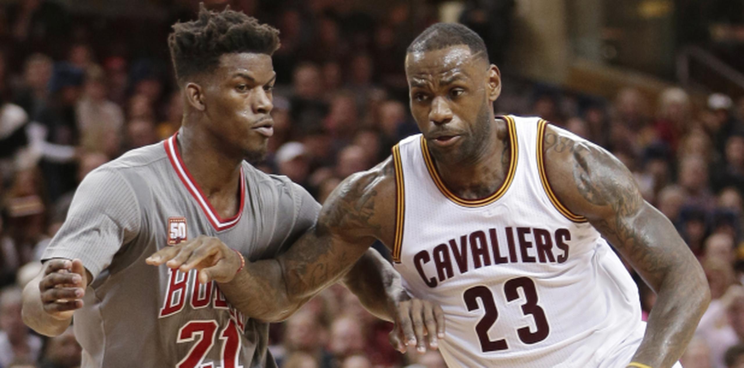 James trata de quitarse de encima la defensa de  Jimmy Butler de los Bulls de Chicago. (AP)