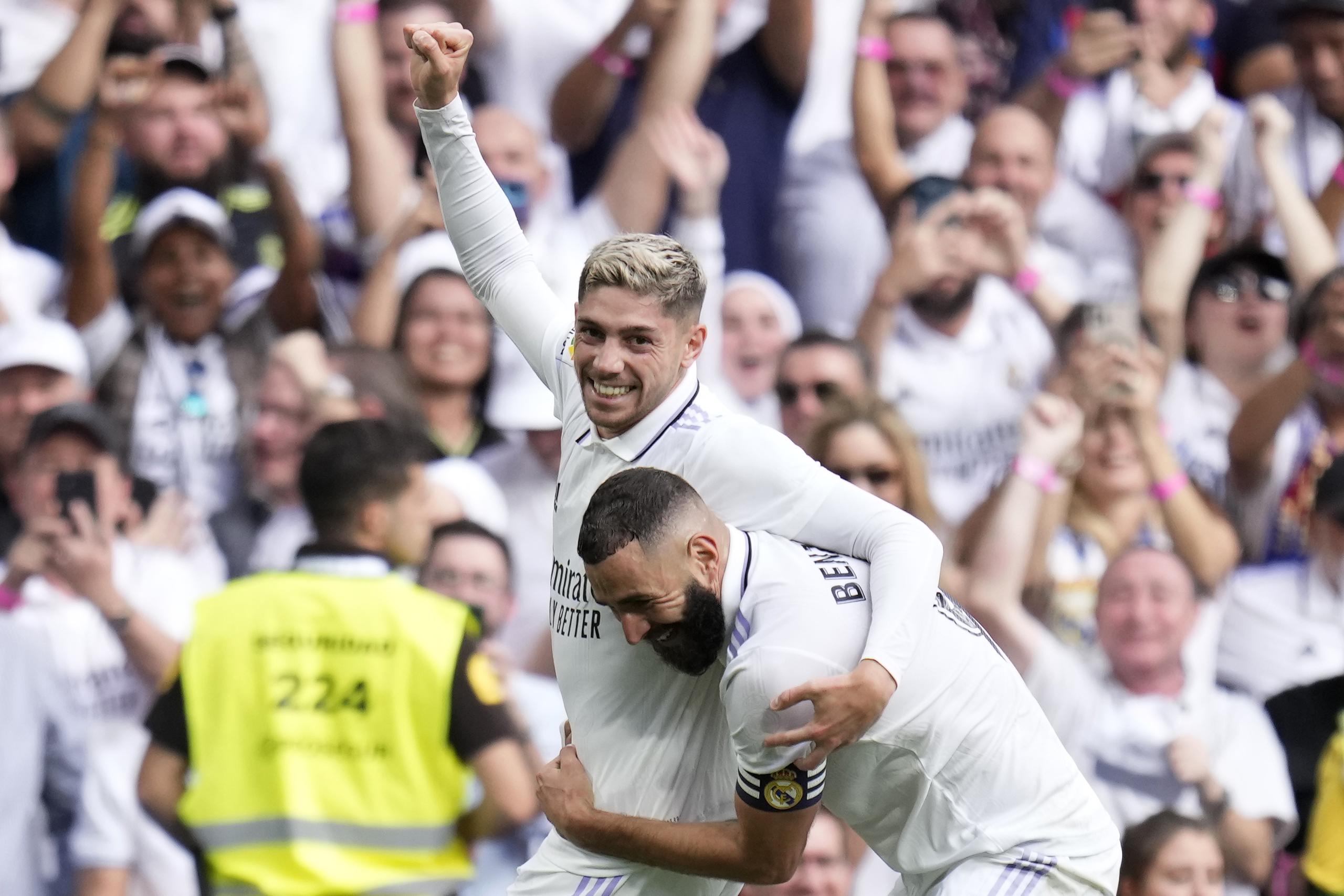 Real Madrid's Federico Valverde celebrates with teammate Karim Benzema, right, after scoring his side's second goal during a Spanish La Liga soccer match between Real Madrid and Barcelona at the Santiago Bernabeu stadium in Madrid, Sunday, Oct. 16, 2022. (AP Photo/Manu Fernandez)