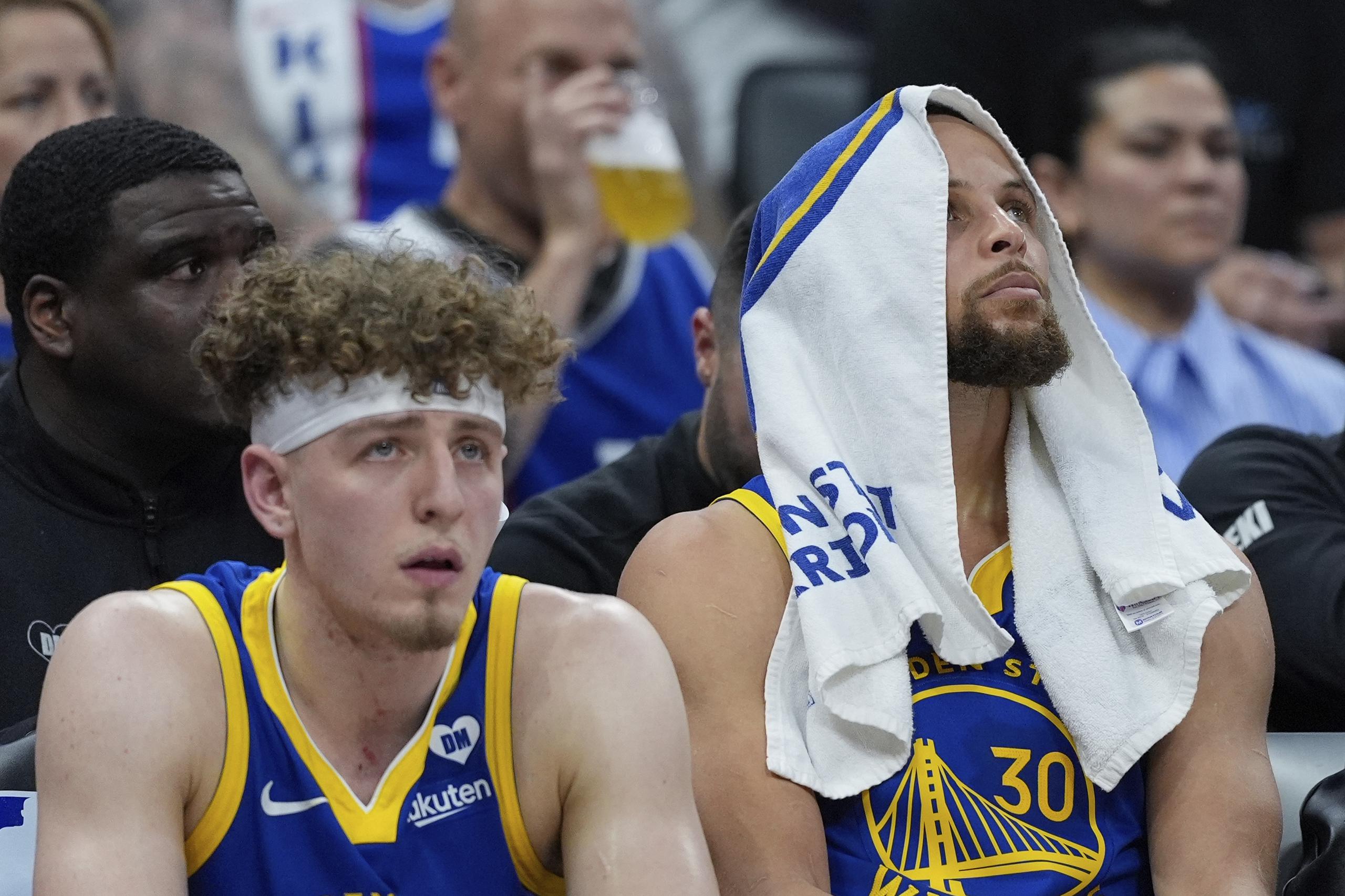 Brandin Podziemski y Stephen Curry aparecen aquí sentados, frustrados, por el evidente desenlace del partido. Los Warriors han quedado fuera de los playoffs por tercera ocasión en los últimos cinco años.