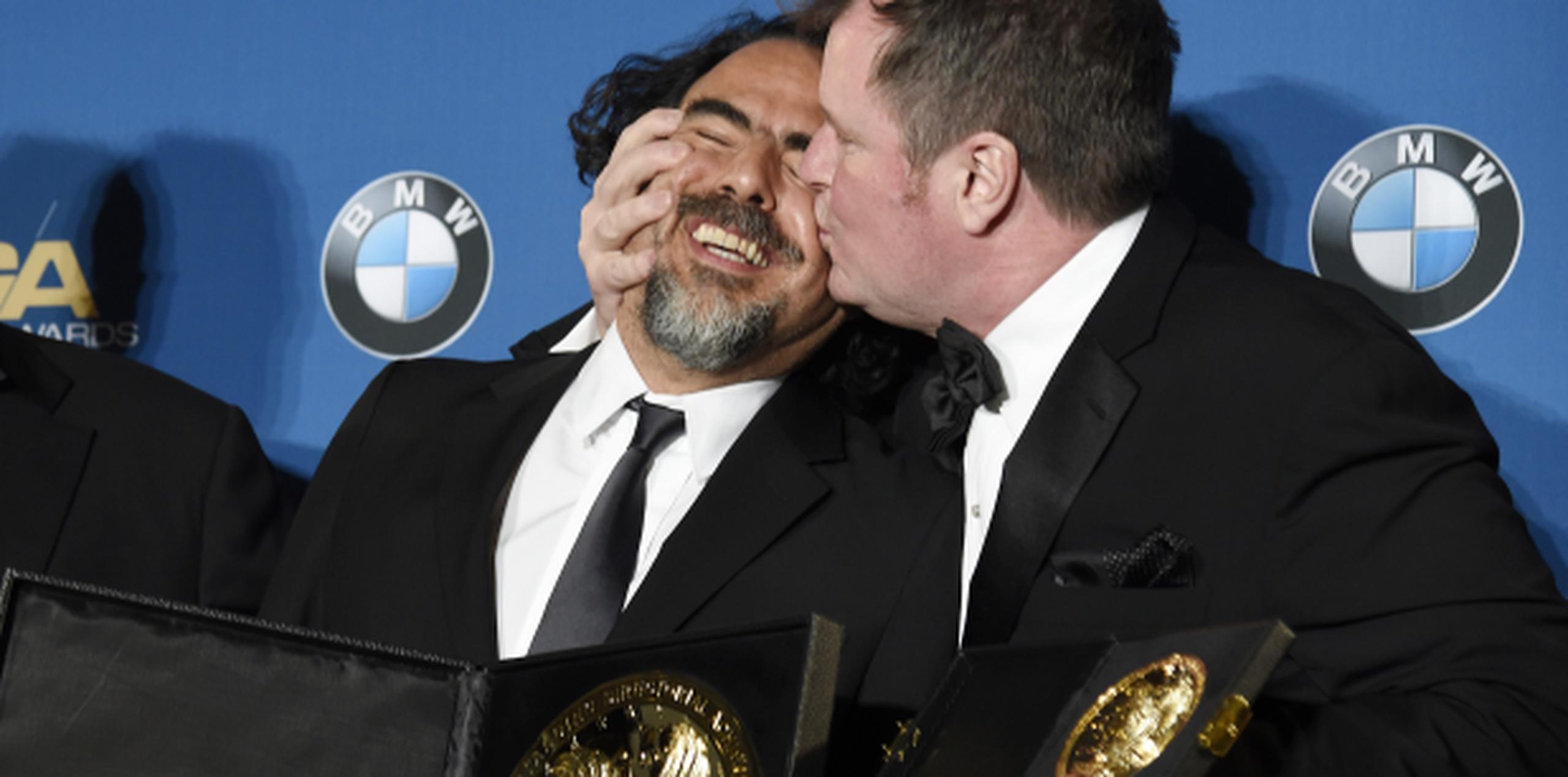 González Iñarritu recibe un beso del productor James Skotchdopole tras ganar otro premio por The Revenant, esta vez del gremio de directores. (AP)