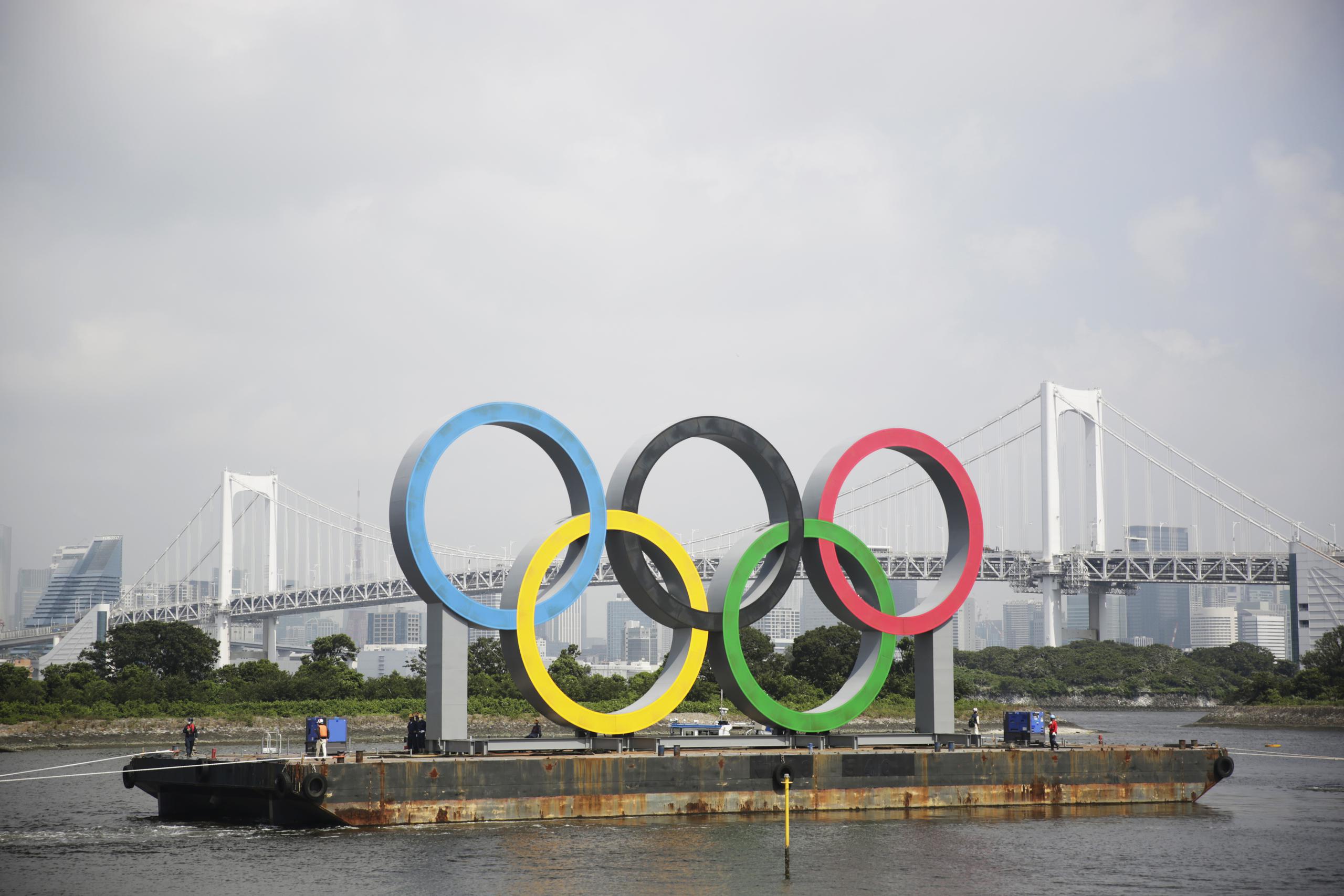 Los anillos olímpicos que flotan sobre una barcaza en una bahía en Tokio fueron removidos recientemente para ser retocados.