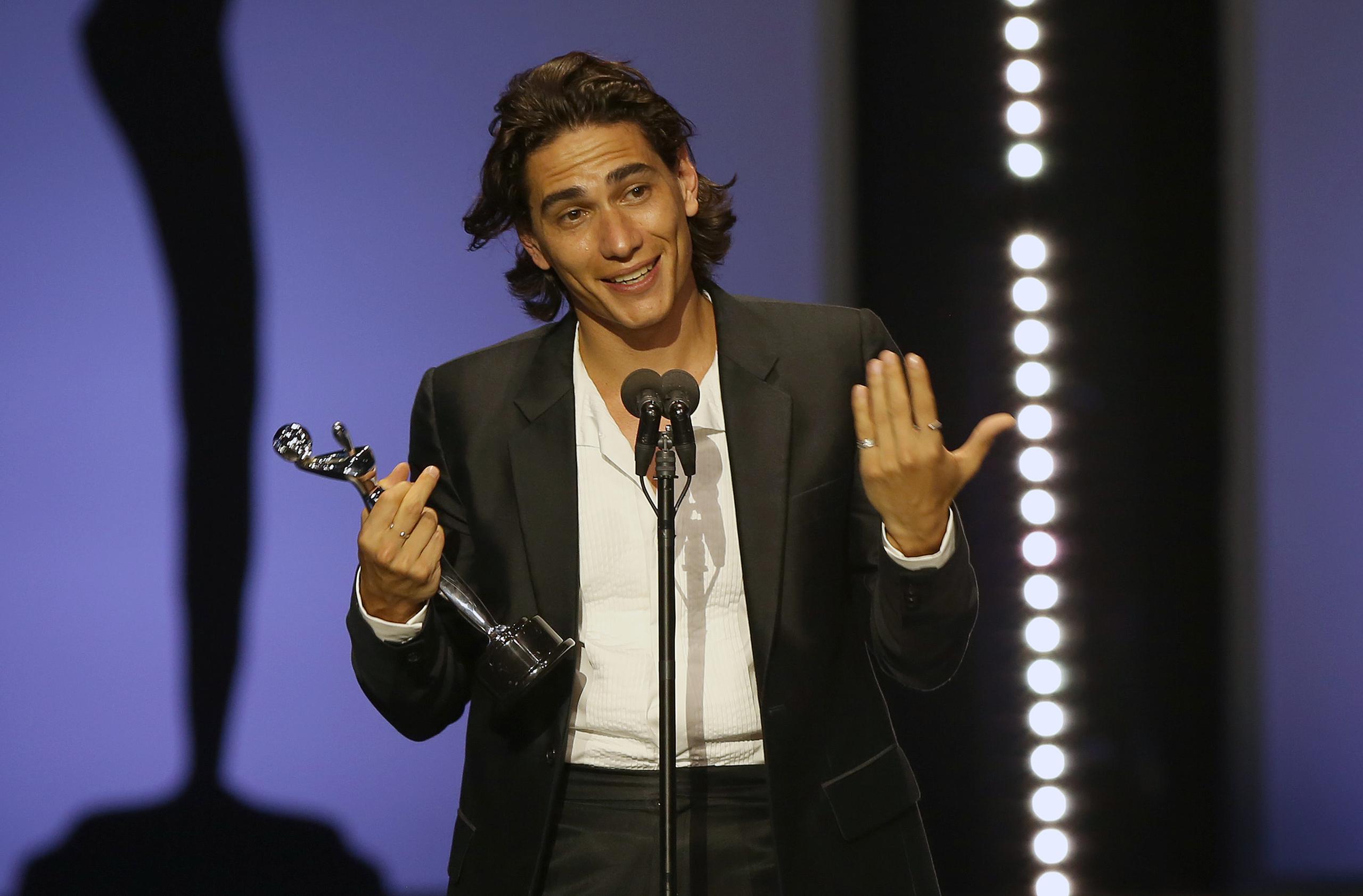 El actor uruguayo Enzo Vogrincicl recibe su premio a mejor actuación masculina por 'La sociedad de la nieve'.