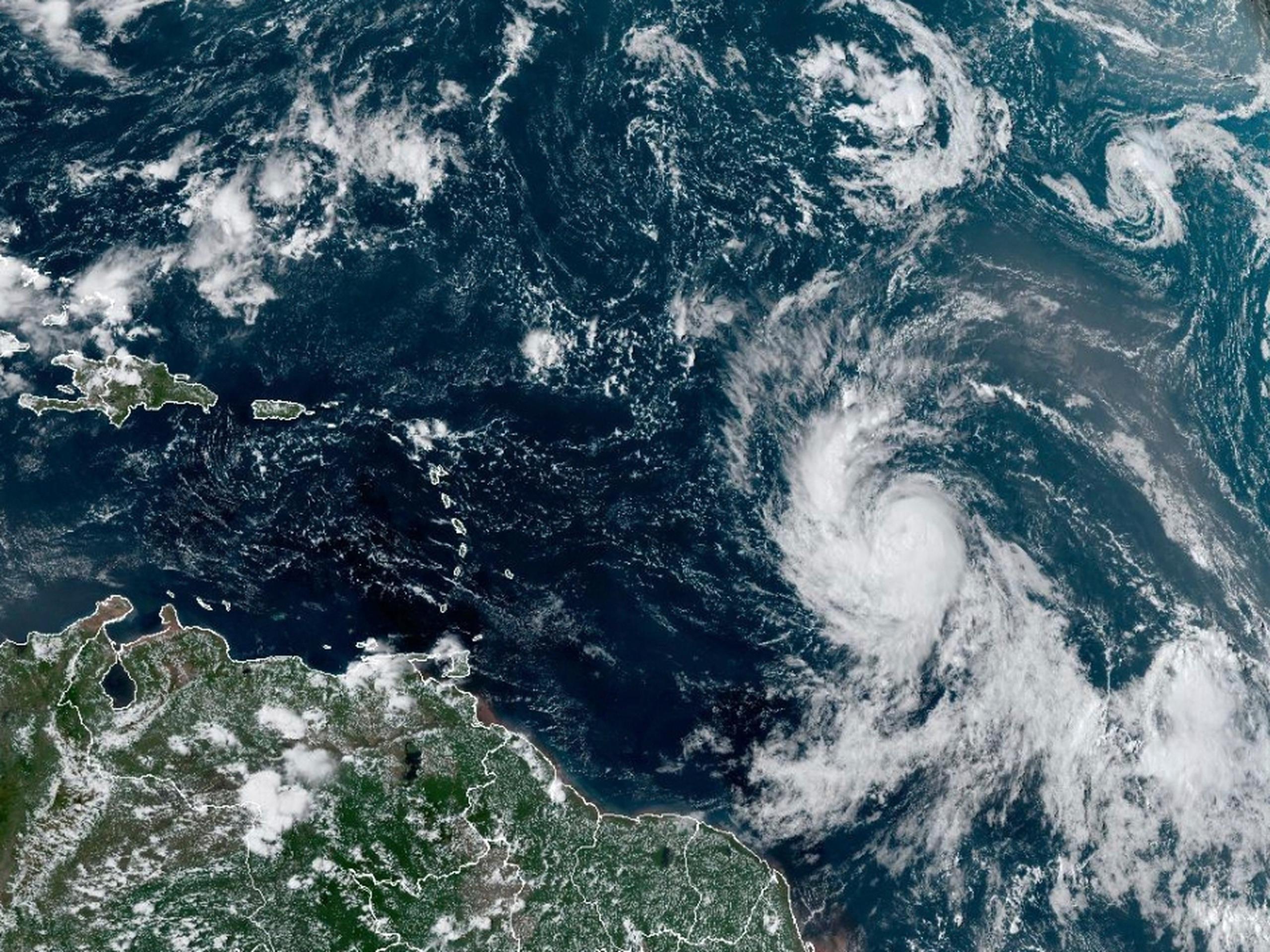 Esta imagen satelital, proporcionada por la Oficina Nacional de Administración Oceánica y Atmosférica de Estados Unidos el miércoles 6 de septiembre de 2023, muestra al huracán Lee (derecha), en el Océano Atlántico. (NOAA vía AP)