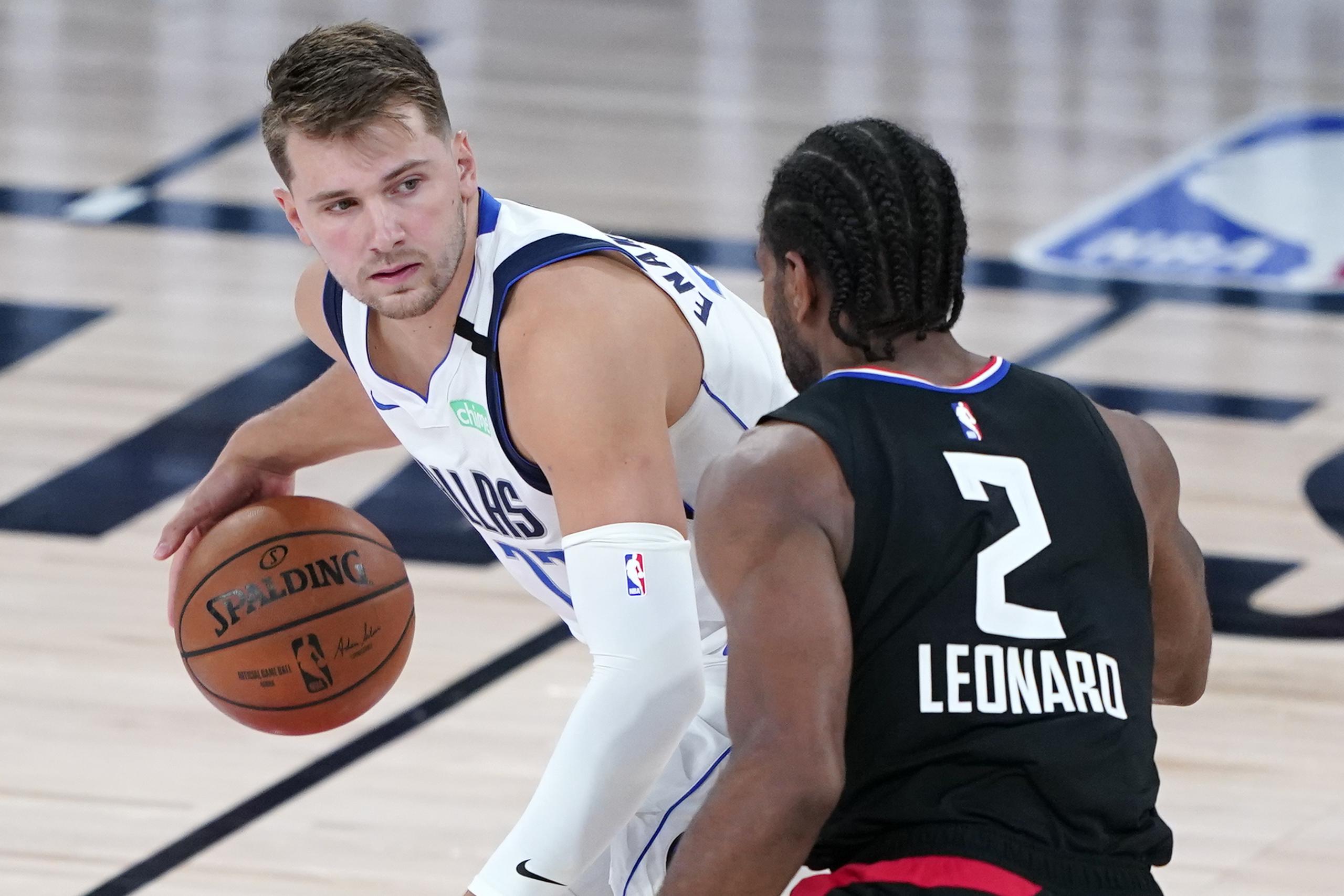 Luka Doncic, de los Mavericks de Dallas, busca eludir a Kawhi Leonard, de los Clippers de Los Ángeles, en el partido del miércoles.