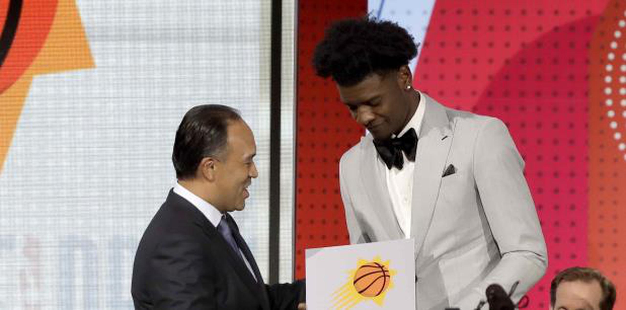 El subcomisionado de la NBA, Mark Tatum, felicita a Josh Jackson, de los Suns de Phoenix. (AP Foto/Charles Rex Arbogast)