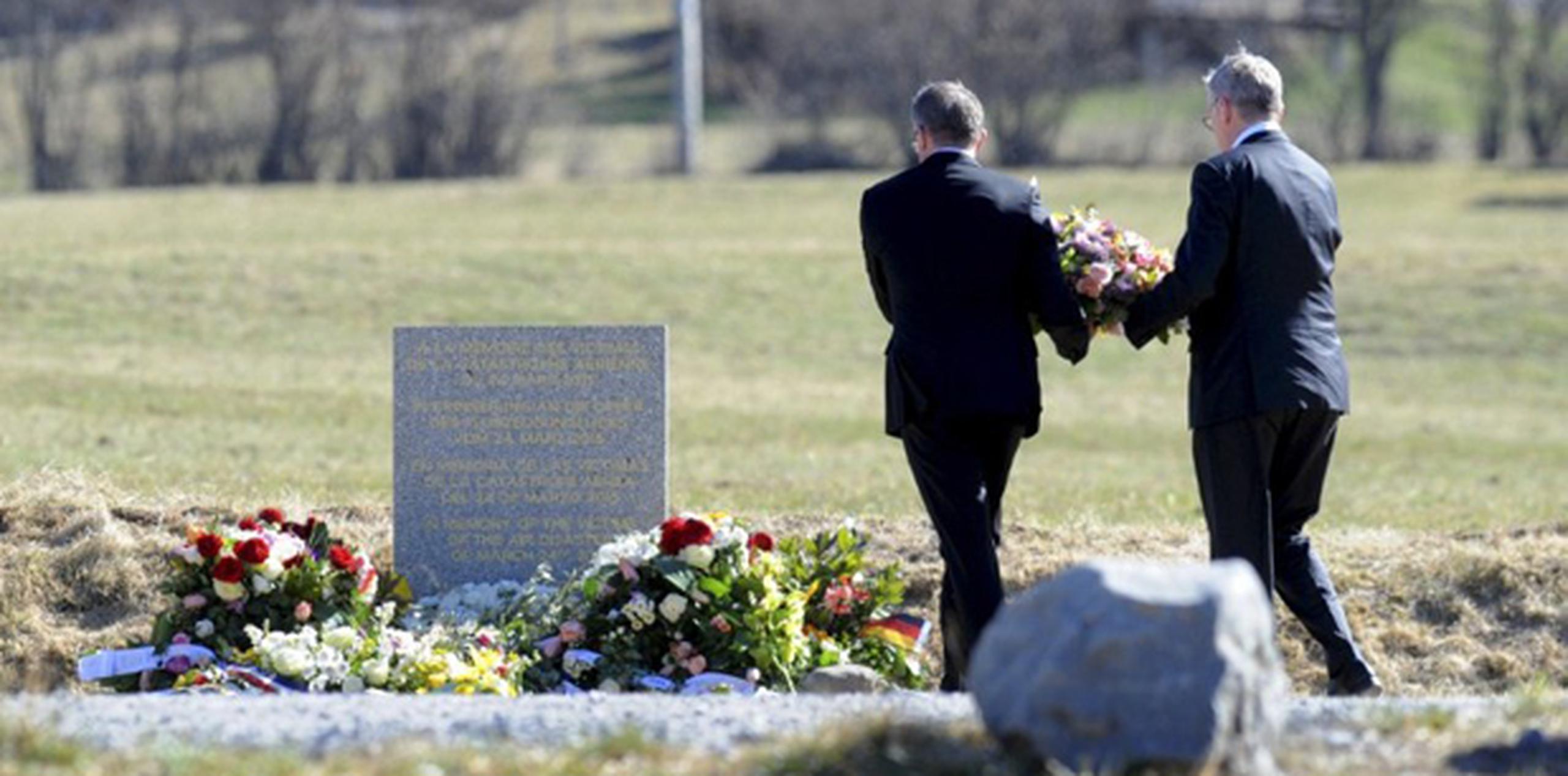 Los dos hombres depositaron flores y permanecieron en silencio frente al monolito de piedra que recuerda a las 150 víctimas del siniestro.  (AP)