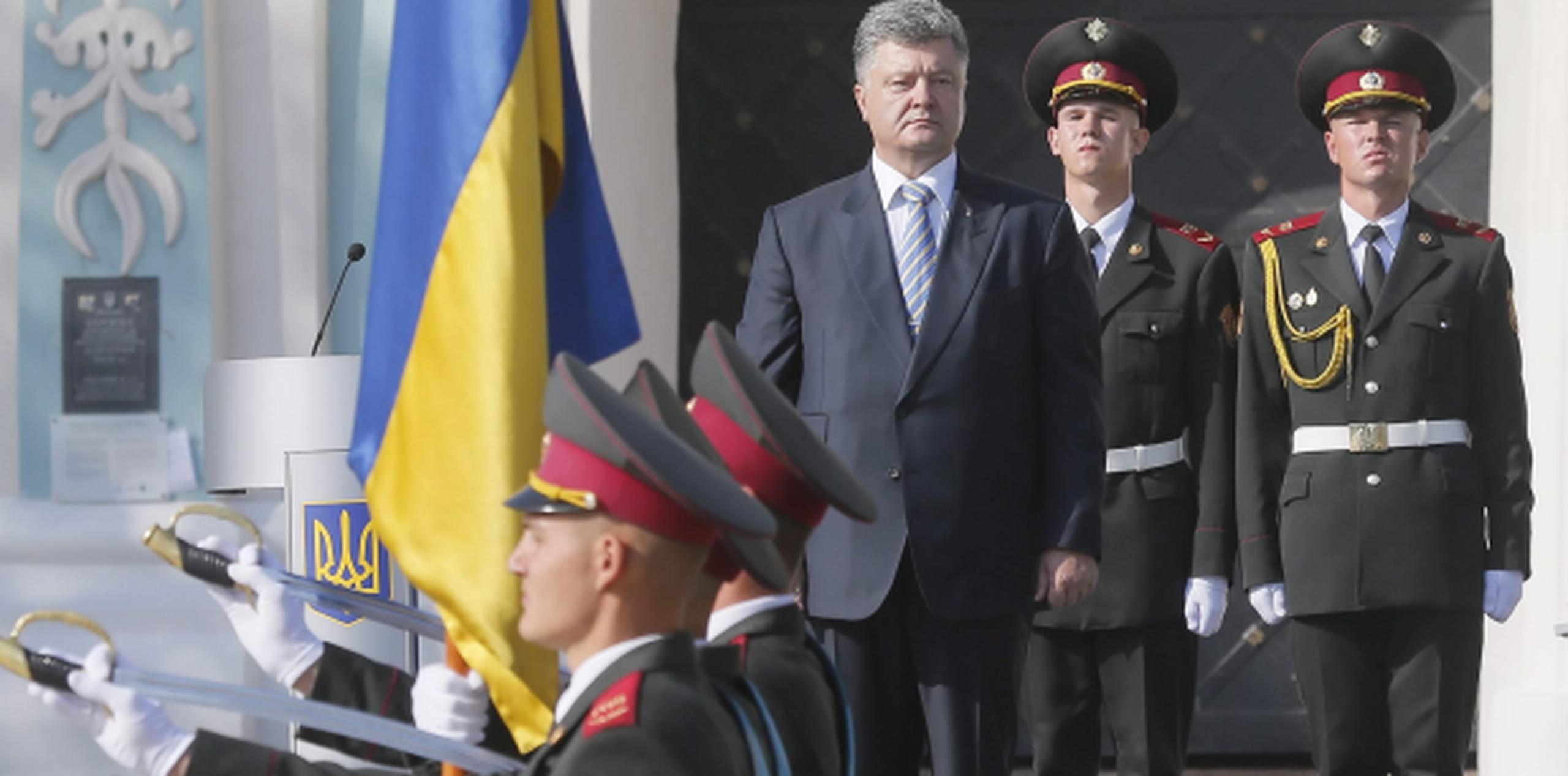 El presidente Petro Poroshenko, al centro, participa de una guardia de honor durante el Día de la Bandera, actividad que precede la celebración mañana de la independencia de Ucrania. (EFE)