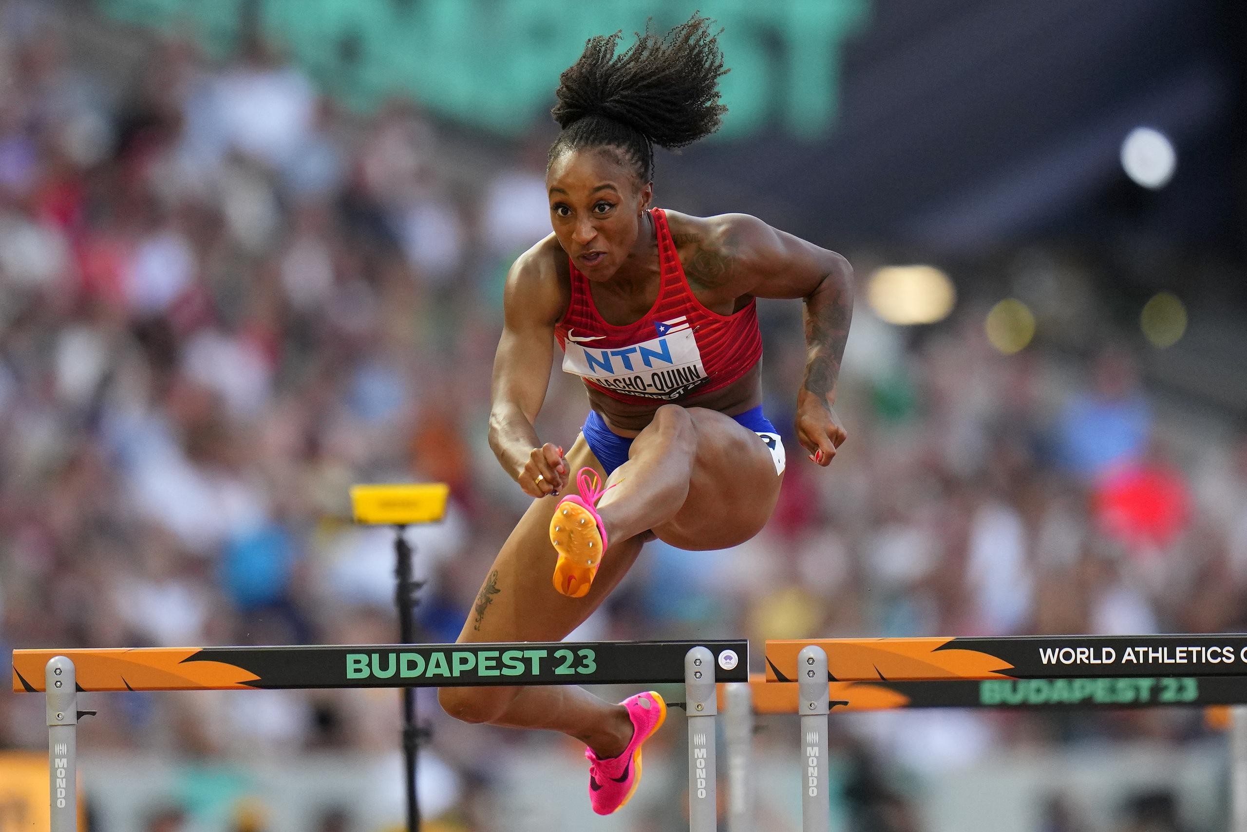 Jasmine Camacho-Quinn, of Puerto Rico competes in a Women's 100-meters hurdles heat during the World Athletics Championships in Budapest, Hungary, Tuesday, Aug. 22, 2023. (AP Photo/Petr David Josek)