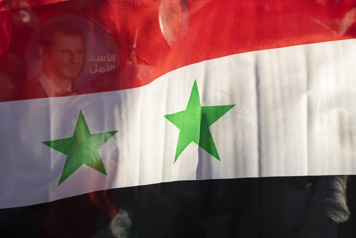 La bandera nacional de Siria desplegada en una concentración en la Plaza Omayyid, en Damasco, el 23 de mayo de 2021.