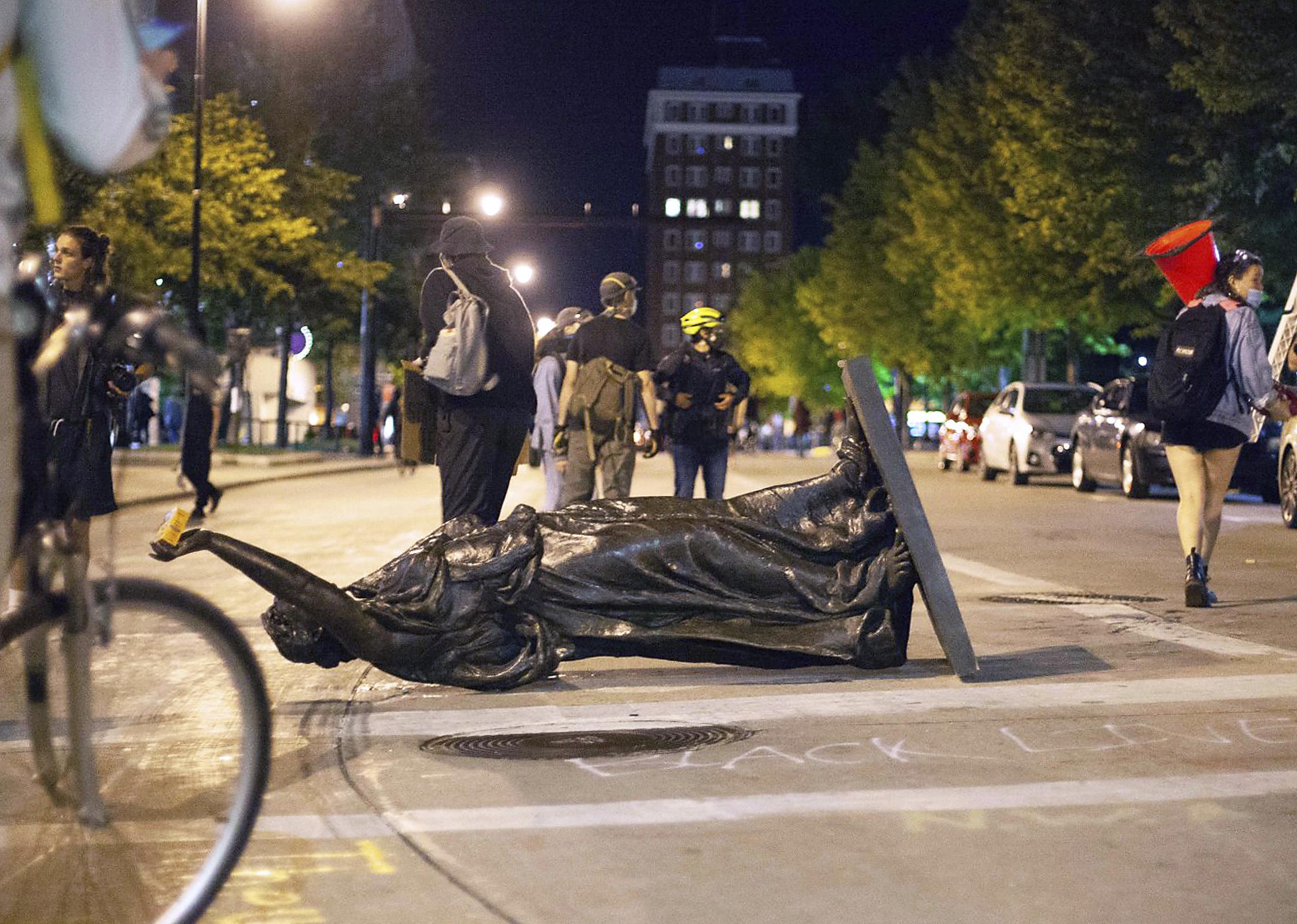 Una estatua derribada por manifestantes durante una protesta en Madison, Wisconsin, la noche del martes 23 de junio de 2020.