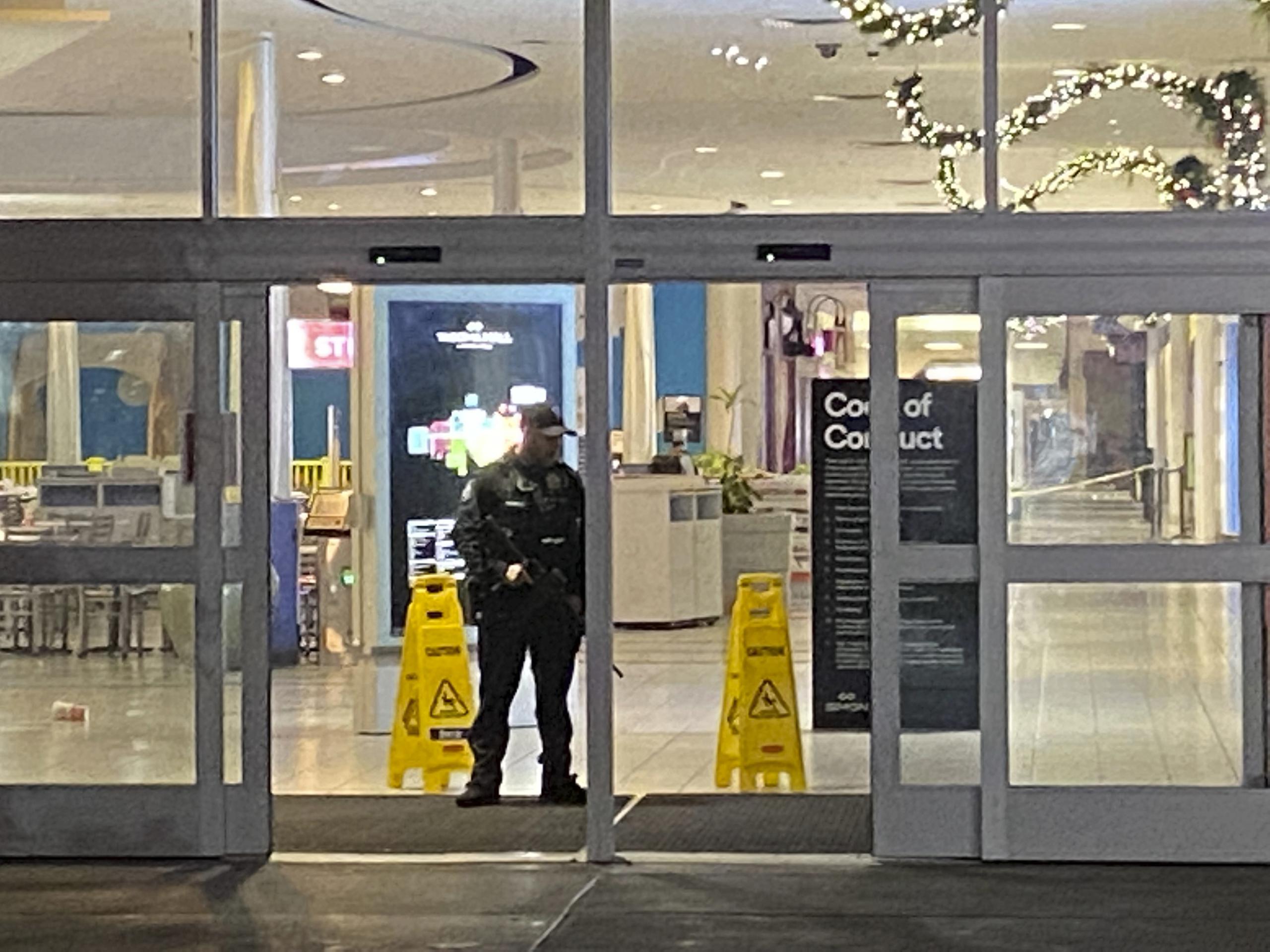 Un oficial vigila una entrada al centro comercial Tacoma Mall el viernes 26 de noviembre de 2021 en Tacoma, Washington. Se escucharon disparos en el centro comercial más temprano en la noche y una persona recibió un disparo. (Craig Sailor / The News Tribune vía AP)