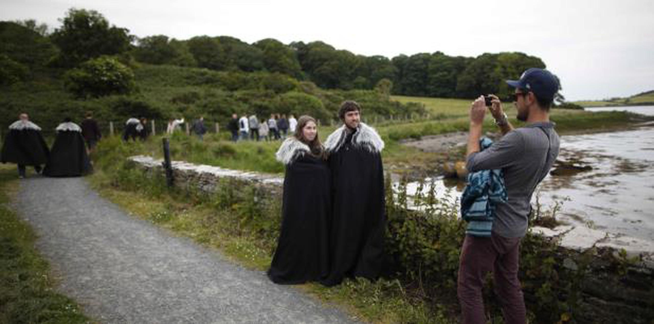 Fanáticos de "Game of Thrones" se toman fotos en camino al prado y castillo de Audley, en Strangford, en el norte de Irlanda, lugar que sirvió de escenario para la primera temporada de la serie. (AP / Peter Morrison)