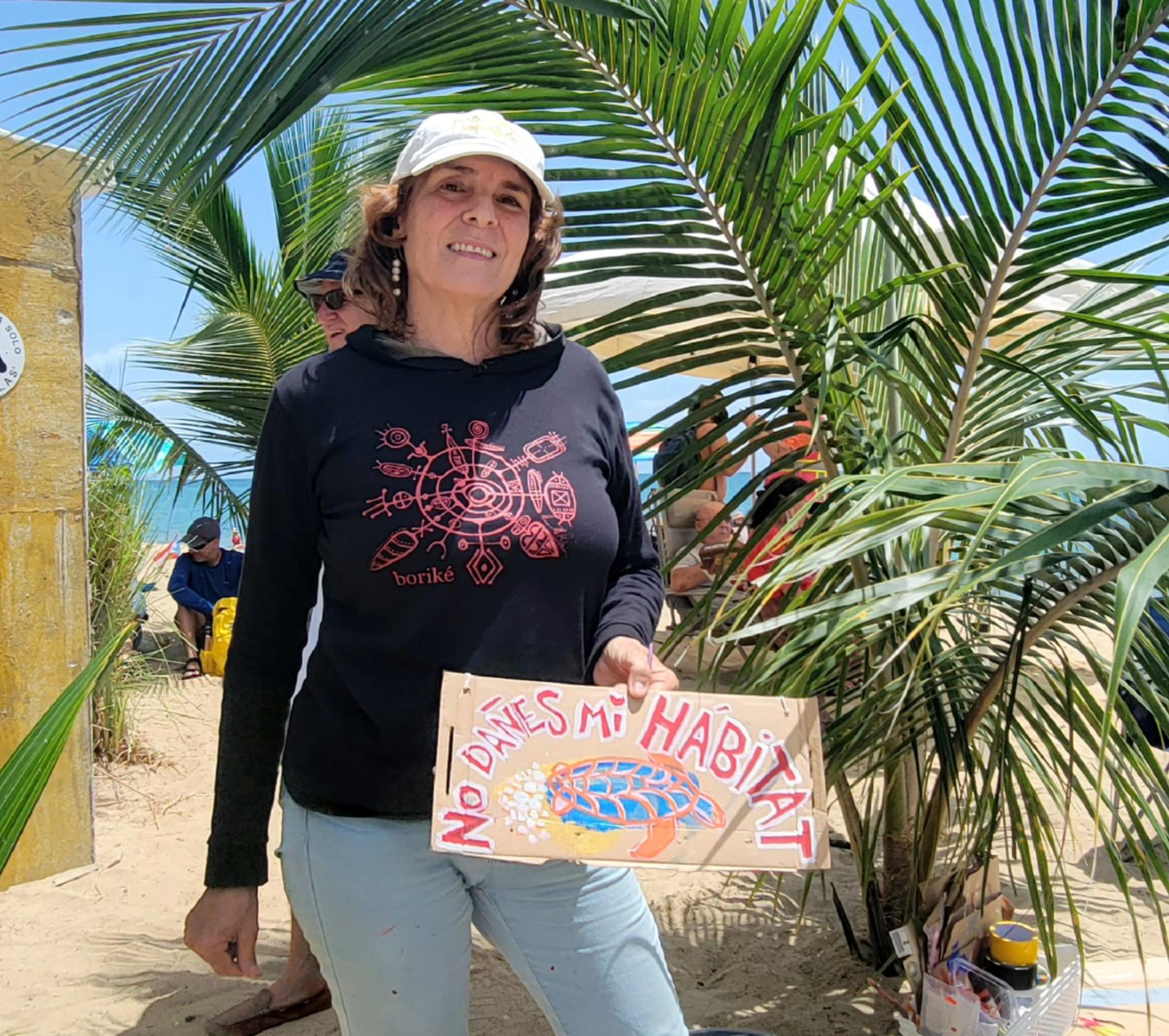 En la foto, Anette Blasini, quien se apostó a un lado de la manifestación para pintar en vivo las incidencias del día, en rótulos que luego expone en distintas partes de la playa.