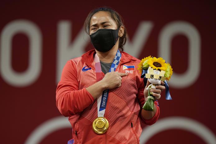 Hidilyn Diaz, de Filipinas, se emociona en el podio luego de colgarse oro, el primero en la historia de su país.