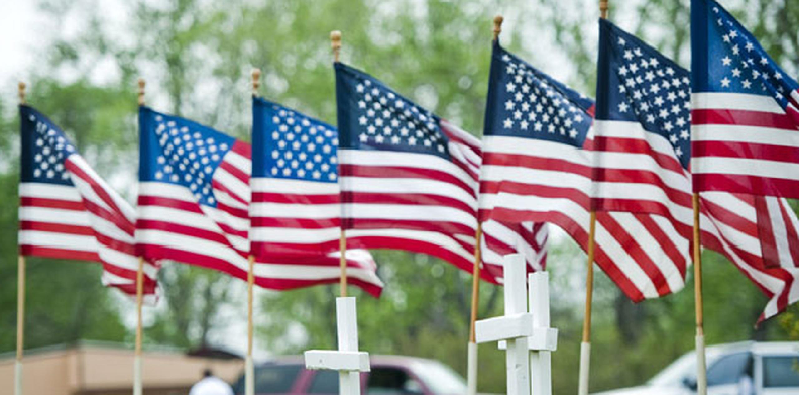 Banderas y cruces representando a las víctimas del tiroteo en Fort Hood decoran la entrada de la iglesia Central Christian Church.(EFE)