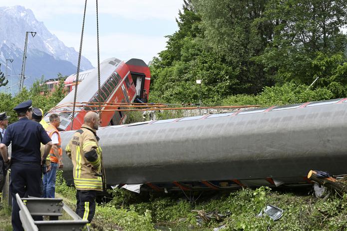 Rescatistas trabajan en el sitio donde se descarriló un tren en Burgrain, cerca de Garmisch-Partenkirchen, Alemania, el sábado 4 de junio de 2022. (Angelika Warmuth/dpa vía AP)