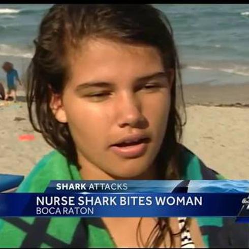 Tiburón se queda aferrado en el brazo de una mujer