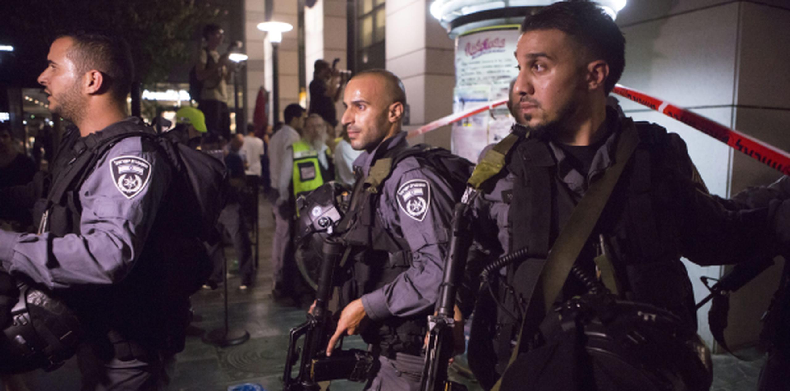 Miembros de la policía israelí irrumpen en el lugar del tiroteo en Tel Aviv, donde tres personas resultaron muertas y unas cinco más heridas. (EFE/JIM HOLLANDER)
