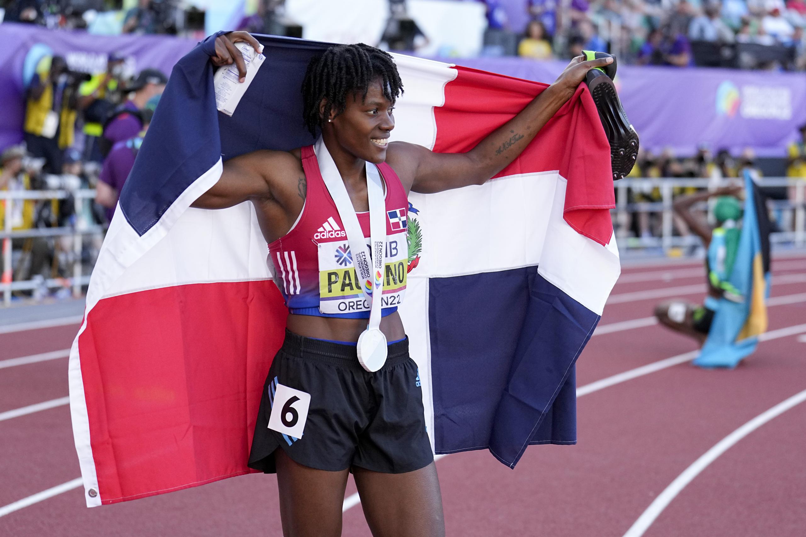 La dominicana Marileidy Paulino festeja con su bandera tras conseguir la medalla de plata en los 400 metros, durante el Mundial de Atletismo en Eugene, Oregon.