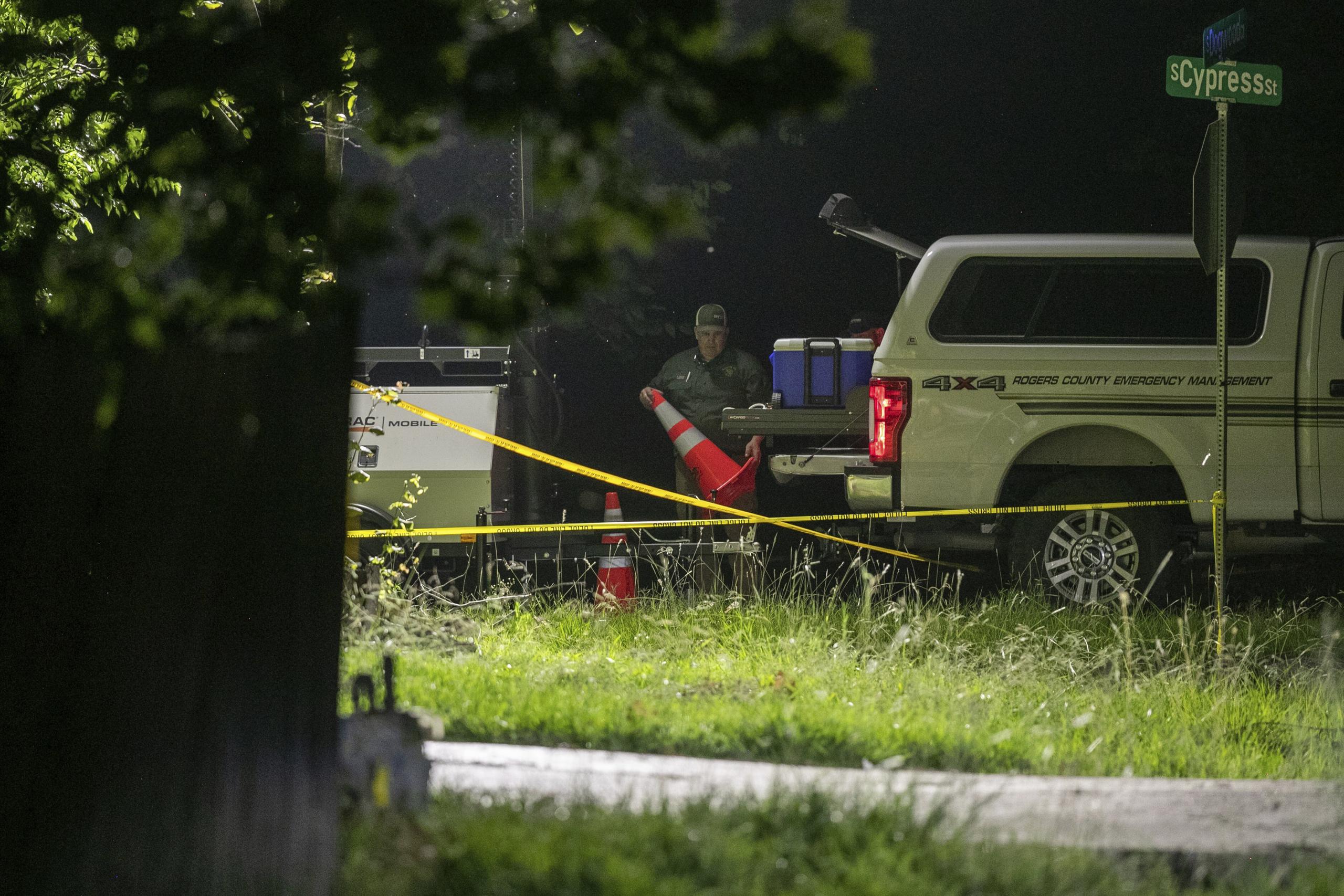 Members of several law enforcement agencies investigate the scene were several people were reportedly killed after a hostage situation on Thursday, July 20, 2023, in Verdigris, Okla. (Daniel Shular/Tulsa World via AP)