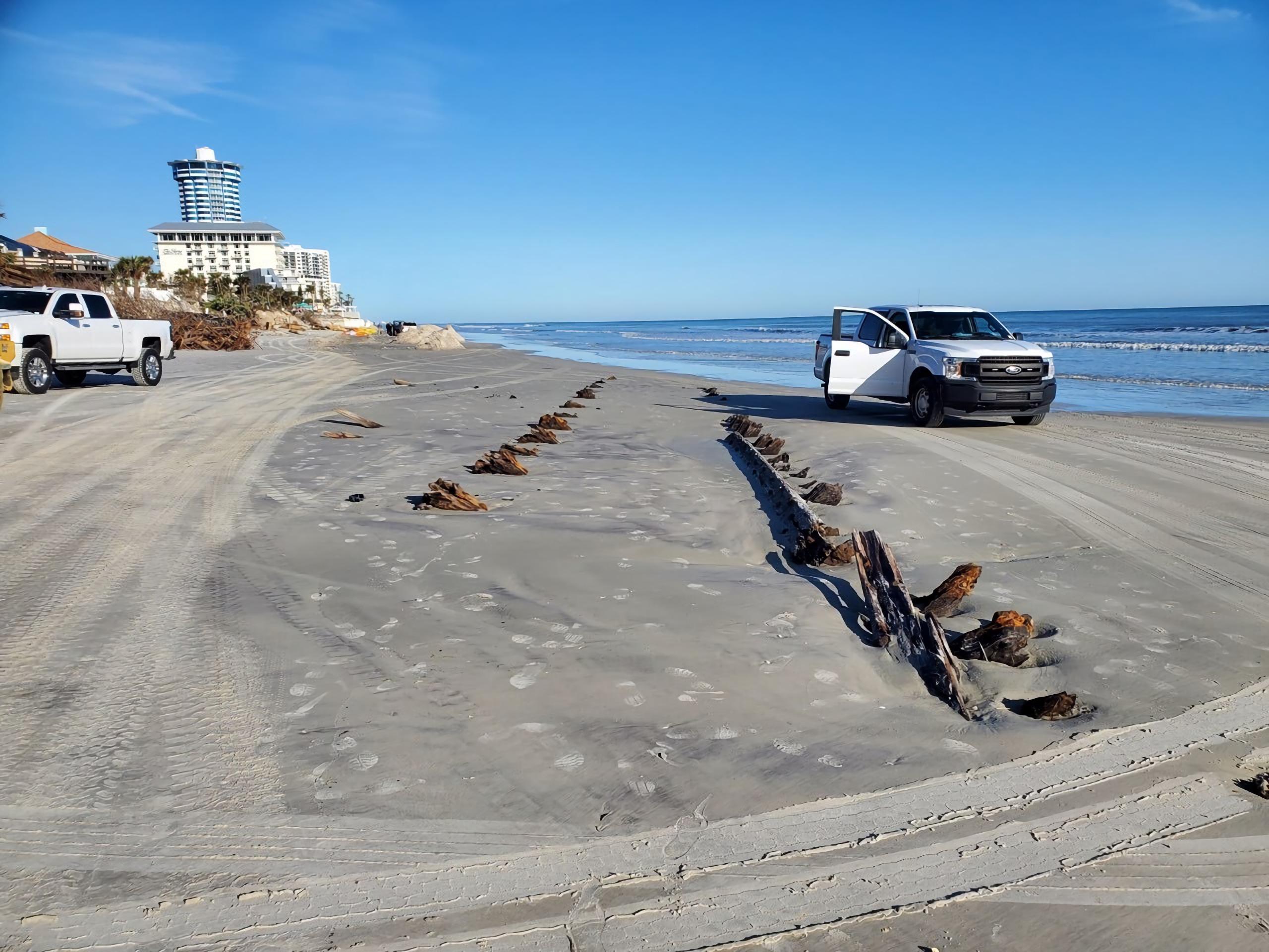 Fotografía cedida por Volusia Beach Safety donde se muestra una vista de los restos de un misterioso objeto, que consisten en un par de hileras de madera que sobresalen de la arena en la playa de Daytona Beach en Florida, en Estados Unidos. (EFE/Volusia Beach Safety)