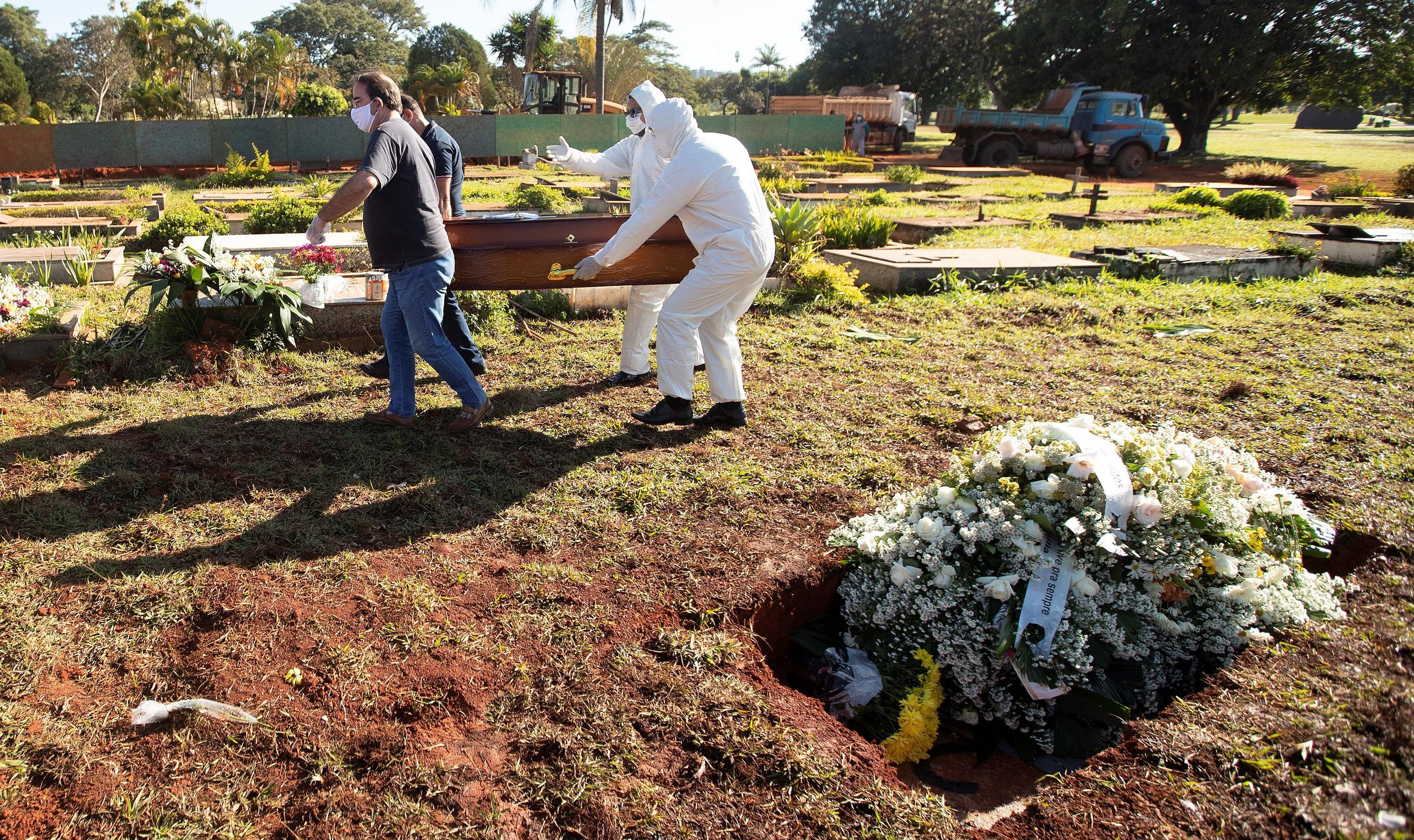 Trabajadores entierran a una víctima de la Covid-19 en Brasilia, Brasil.