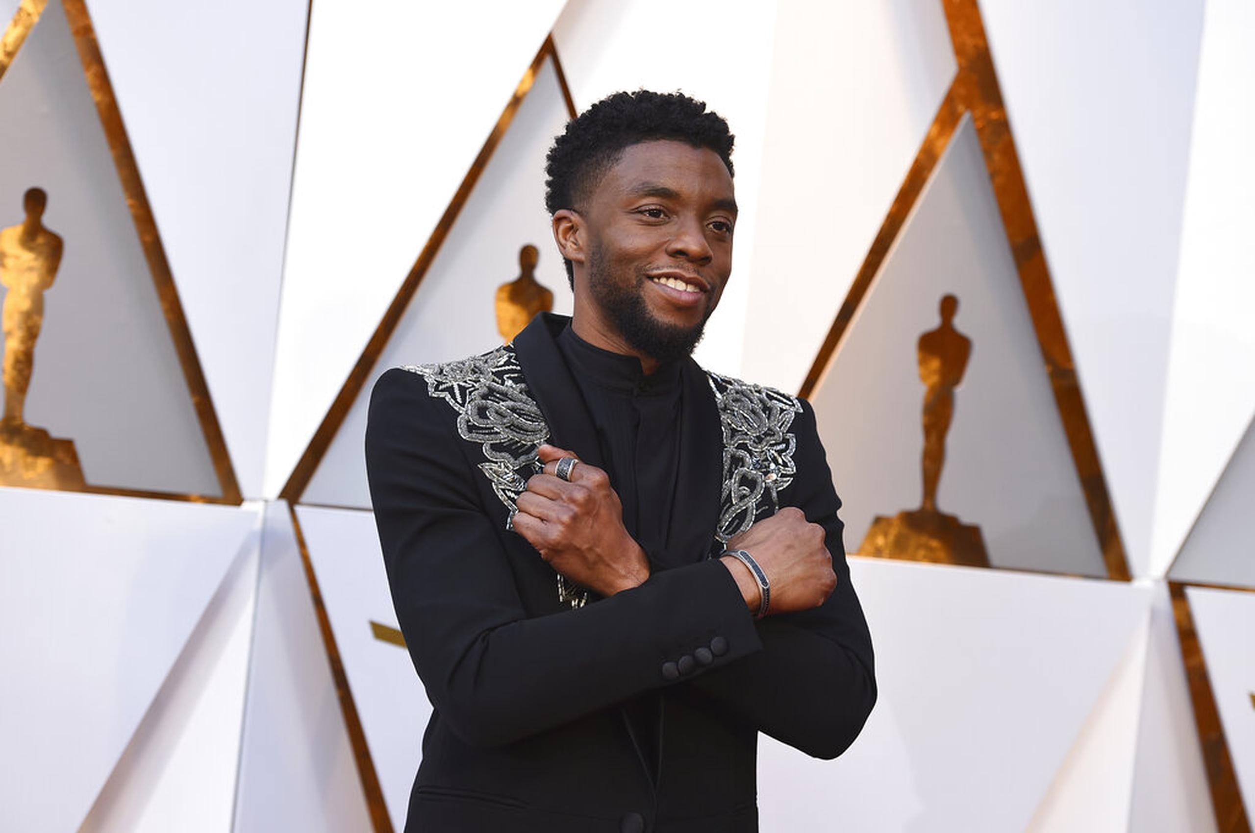 FILE - In this March 4, 2018 file photo, Chadwick Boseman arrives at the Oscars at the Dolby Theatre in Los Angeles.   Actor Chadwick Boseman, who played Black icons Jackie Robinson and James Brown before finding fame as the regal Black Panther in the Marvel cinematic universe, has died of cancer. His representative says Boseman died Friday, Aug. 28, 2020 in Los Angeles after a four-year battle with colon cancer. He was 43.  (Photo by Jordan Strauss/Invision/AP, File)