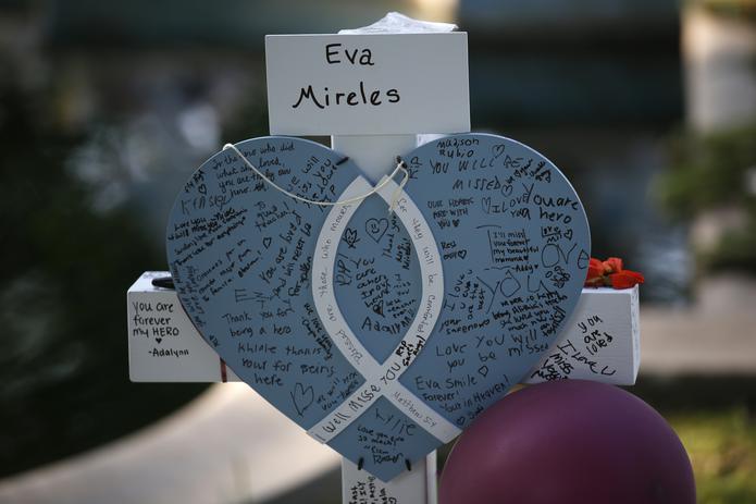Eva Mireles' cross stands at a memorial site for the victims killed in this week's shooting at Robb Elementary School in Uvalde, Texas, Friday, May 27, 2022. (AP Photo/Dario Lopez-Mills)