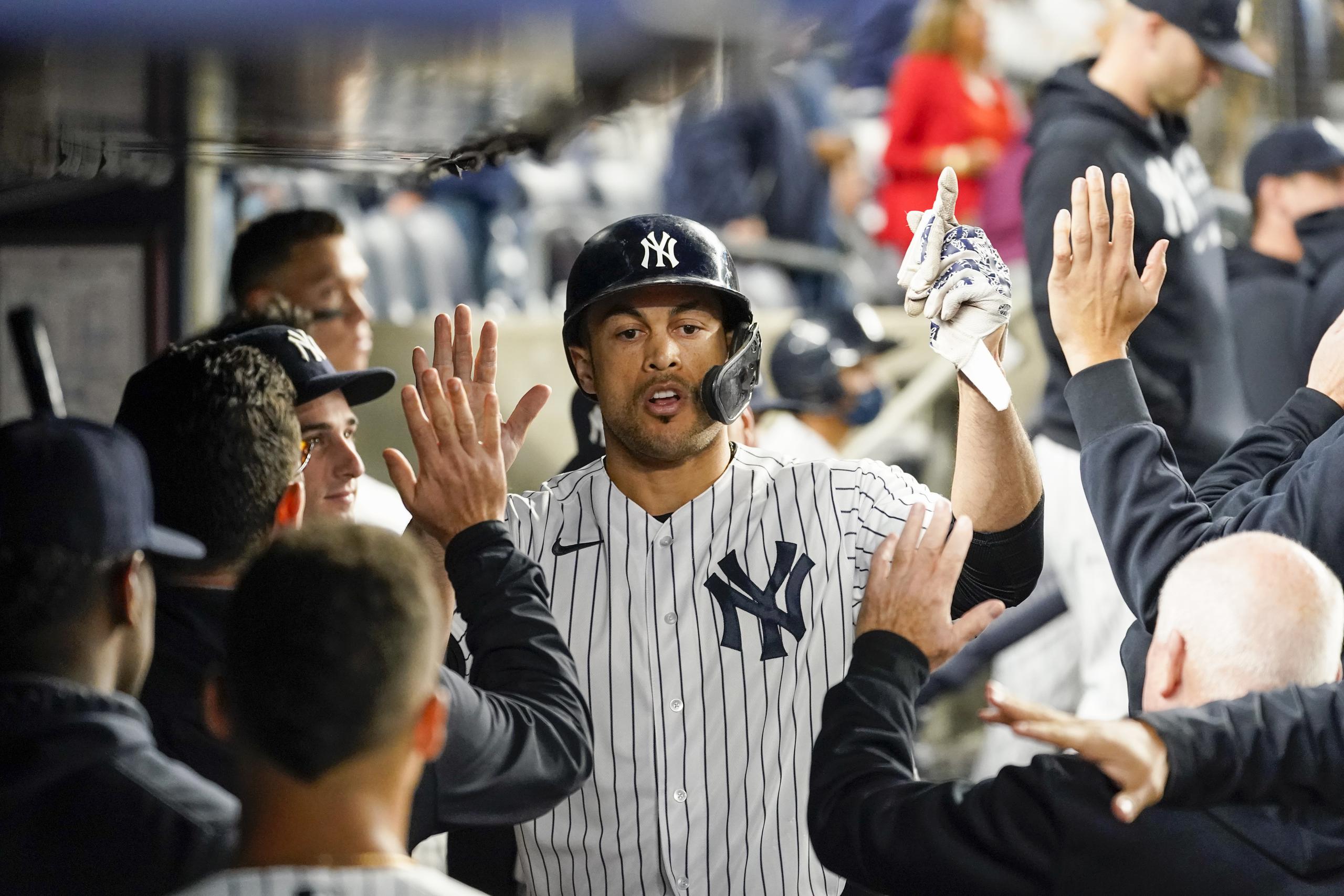 New York Yankees' Giancarlo Stanton celebrates with his teammates after scoring off a bunt by Joey Gallo in the ninth inning of a baseball game against the Tampa Bay Rays, Friday, Oct. 1, 2021, in New York. The Rays won 4-3. (AP Photo/Mary Altaffer)