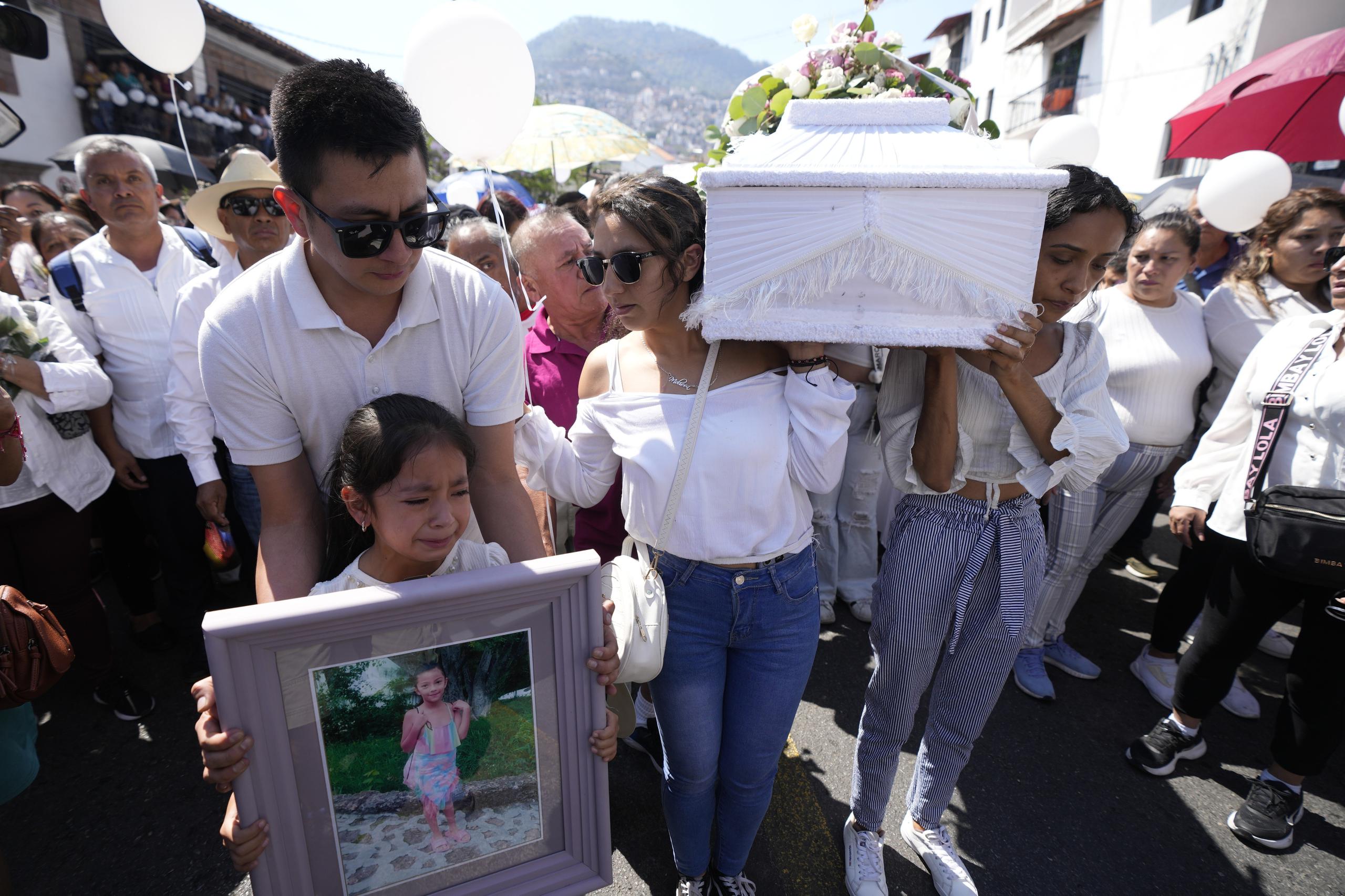 Relatives carry the coffin that contain the remains of a young girl named Camila, in Taxco, Mexico, Friday, March 29, 2024. The 8-year-old girl disappeared Wednesday; her body was found on a road on the outskirts of the city early Thursday. Later that day a mob beat a woman to death because she was suspected of kidnapping and killing the young girl. (AP Photo/Fernando Llano)