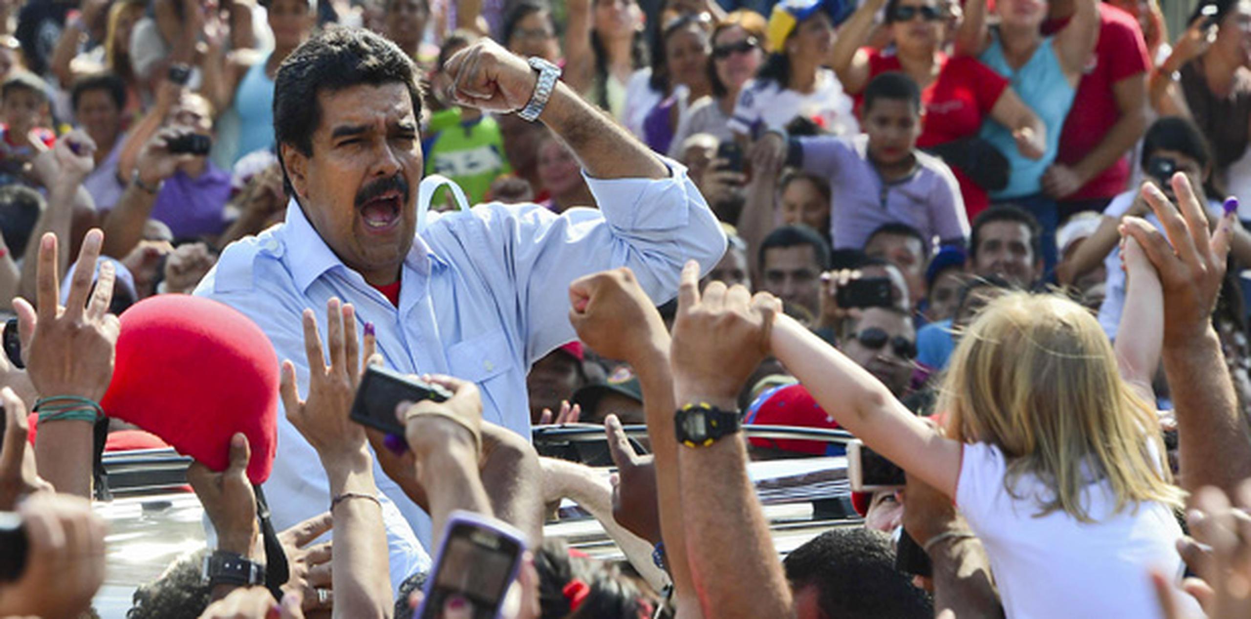 Según los resultados con el 99.1% del recuento efectuado, Maduro ganó con el 50.66 % de los votos. (AFP)