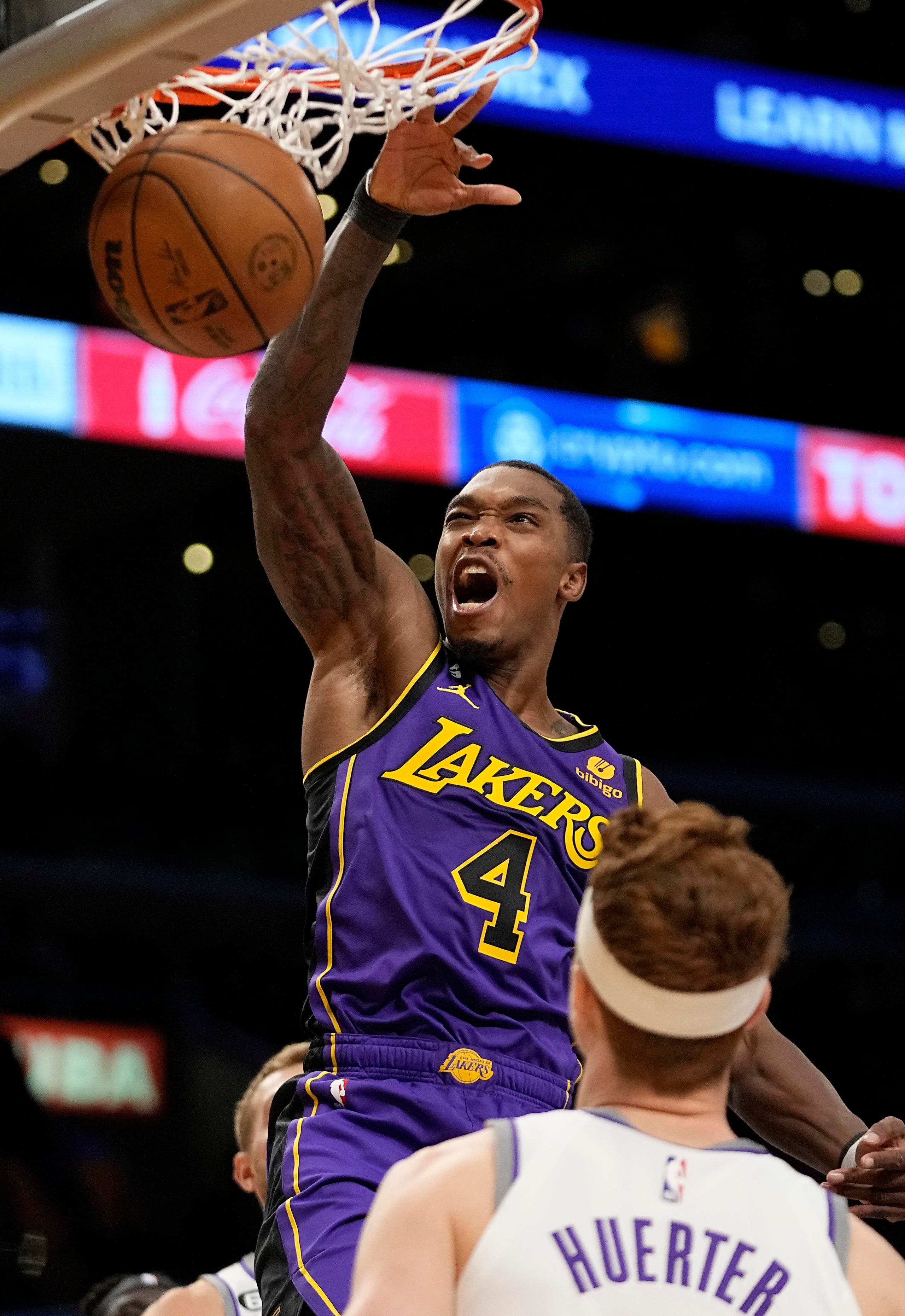 Lonnie Walker IV (4), de los Lakers de Los Ángeles, donquea el balón ante Kevin Huerter, de los Kings de Sacramento, en la primera mitad del juego del viernes.