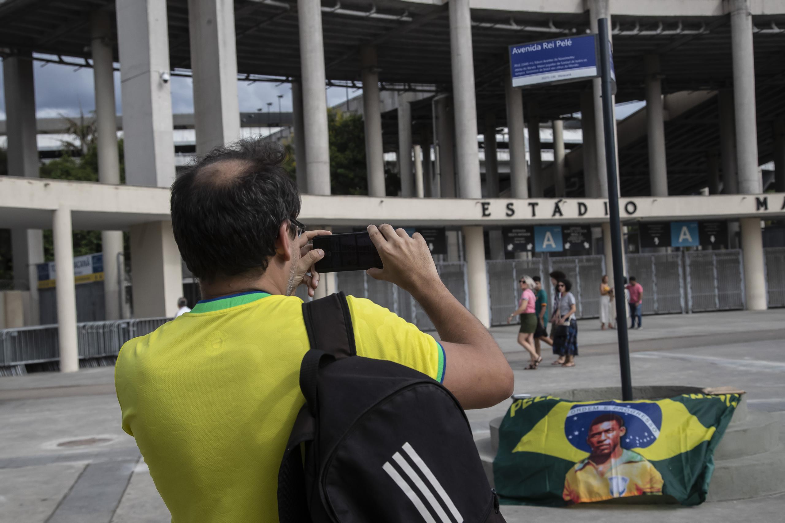 Un hombre fotografía un letrero con el nuevo nombre de la avenida que rodea el Estadio Maracaná en Río de Janeiro. La vía se llama ahora Avenida Rey Pelé.