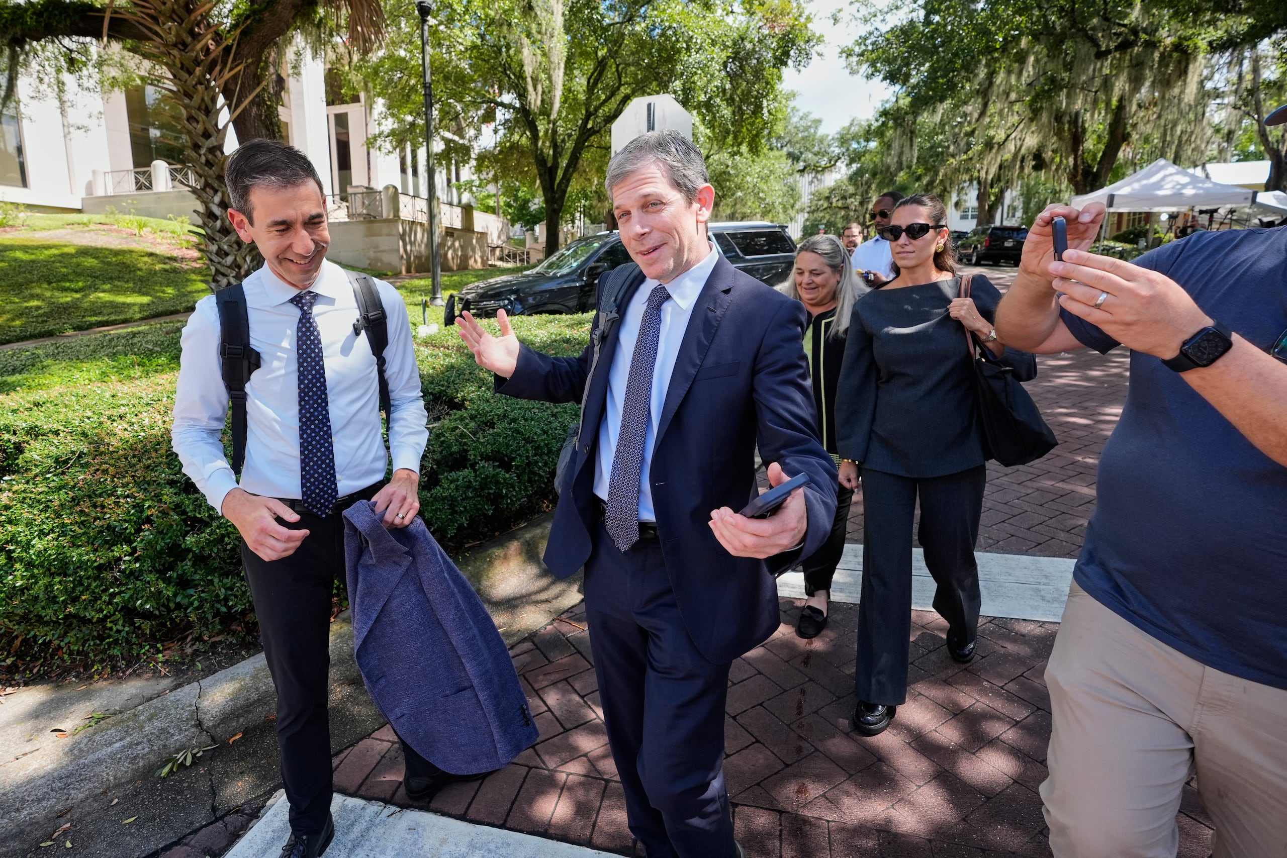 David Oscar Markus, abogado de Ghislaine Maxwell, en el centro, es interrogado por los medios de comunicación afuera del tribunal federal en Tallahassee, Florida, el jueves 24 de julio de 2025. (AP Photo/John Raoux)