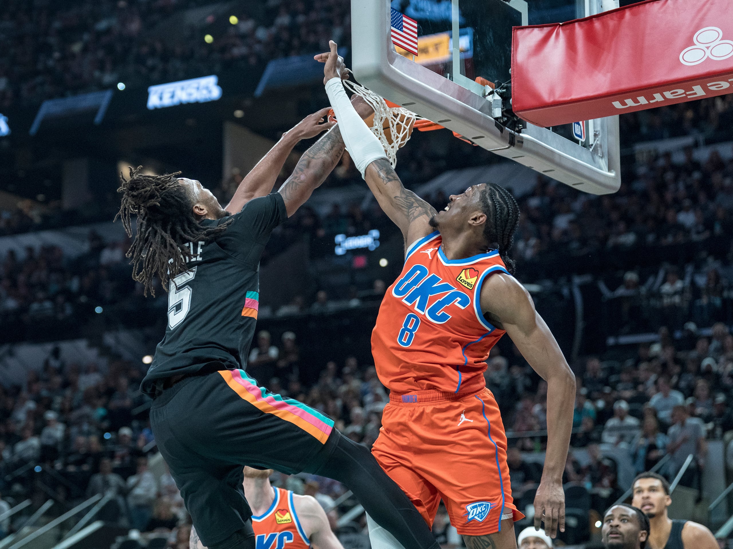 El base de los Spurs de San Antonio Stephon Castle clava el balón sobre Jalen Williams del Thunder de Oklahoma City el martes 23 de diciembre del 2025. (AP Foto/Rodolfo Gonzalez)