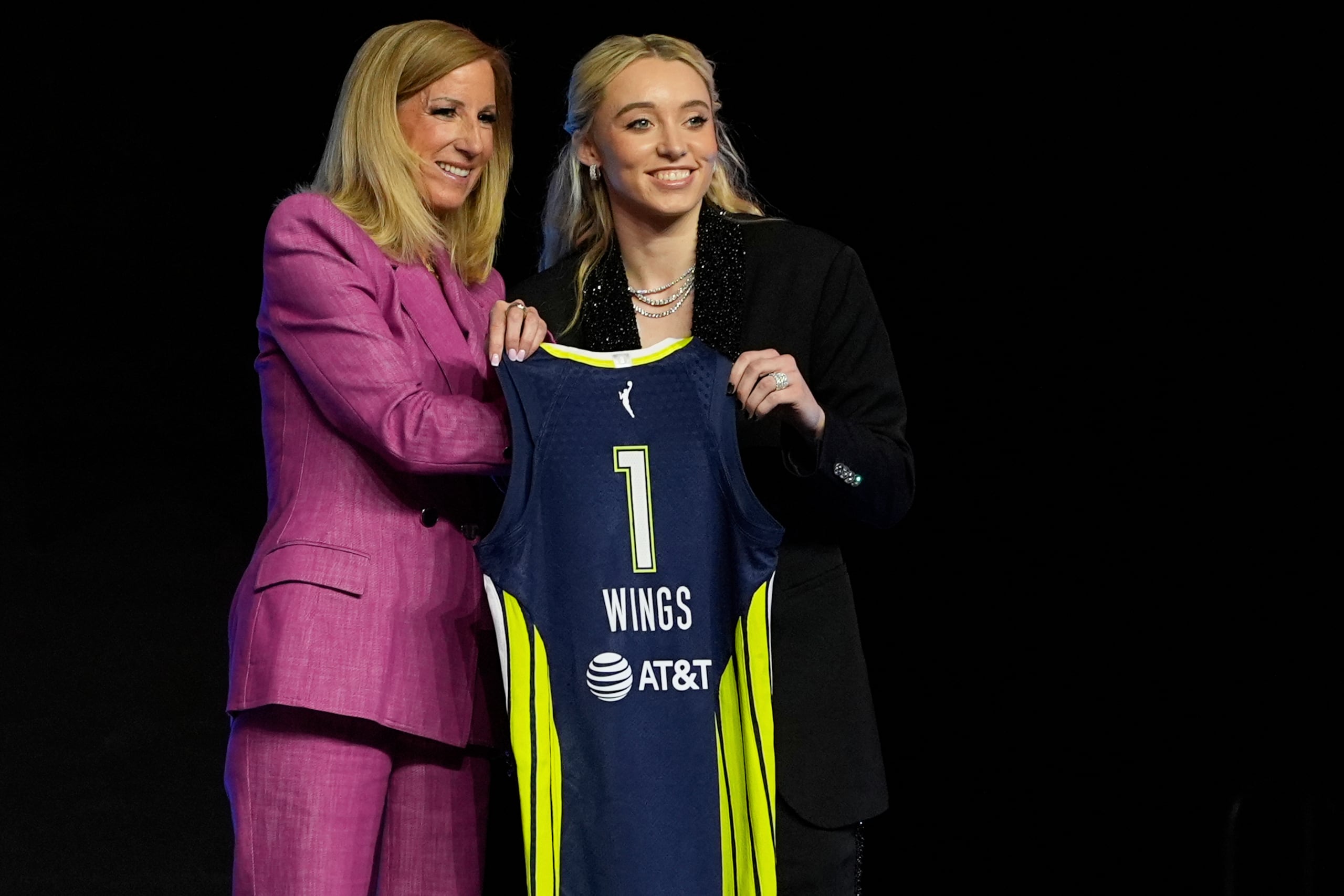 UConn's Paige Bueckers, right, poses for a photo with WNBA commissioner Cathy Engelbert after being selected first overall by the Dallas Wings during the first round of the WNBA basketball draft, Monday, April 14, 2025, in New York. (AP Photo/Pamela Smith)