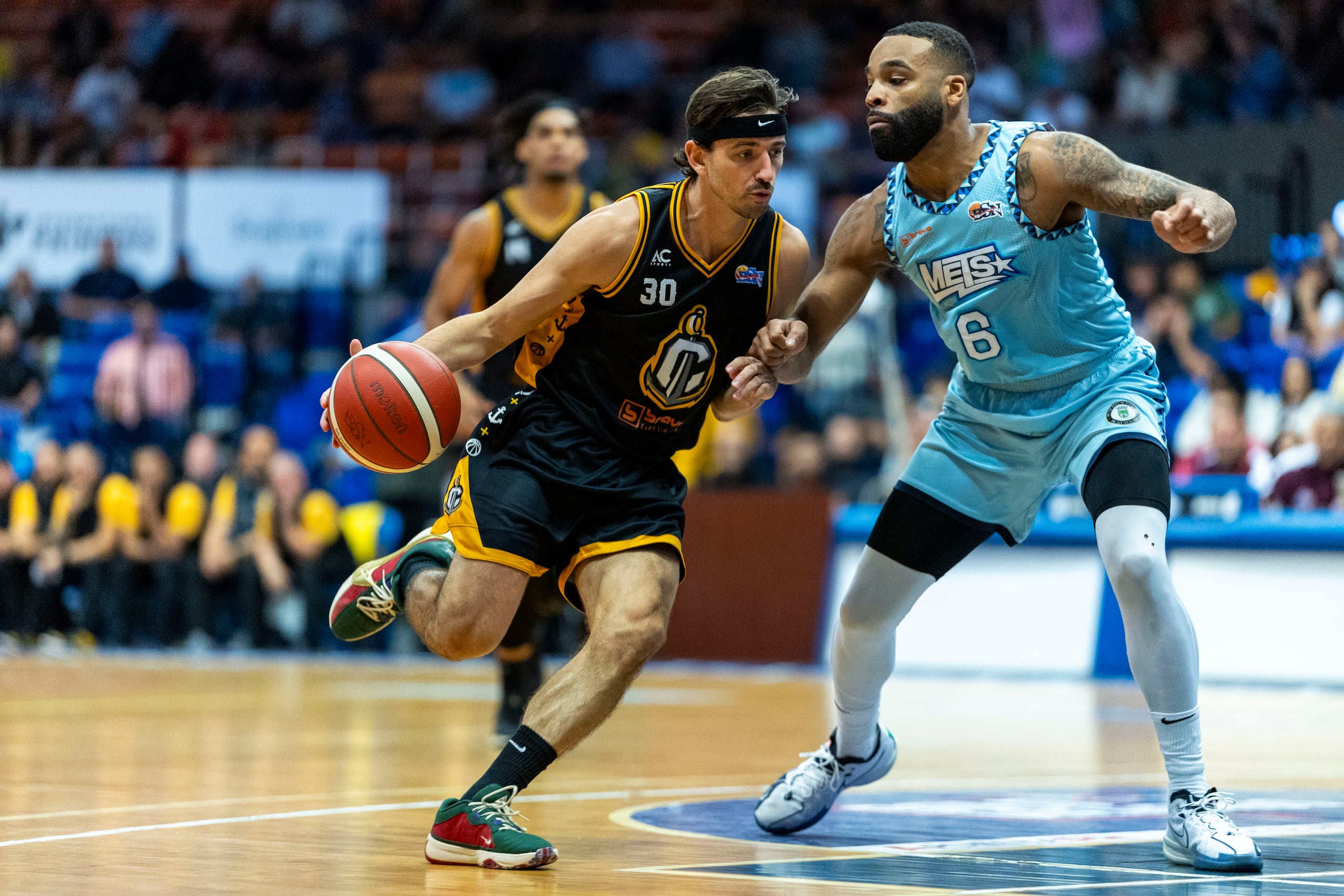 David Stockton, de los Capitanes de Arecibo, busca atacar el canasto ante la defensa de Jaysean Paige, de los Mets de Guaynabo.