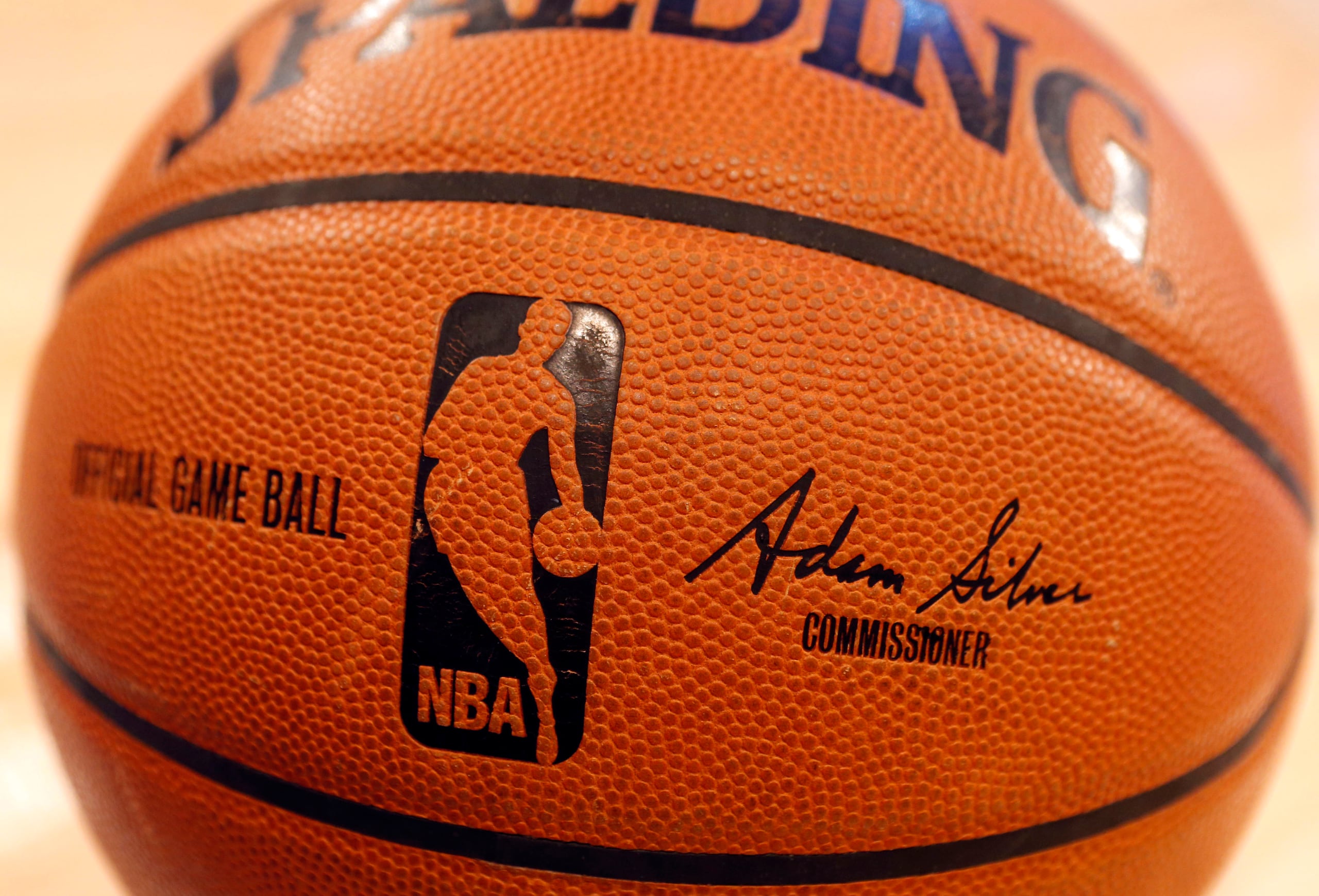 FILE - An NBA logo is seen on an official game ball before a basketball game, Feb. 1, 2014, in New York. The NBA said Wednesday, July 24, 2024 that it is not accepting Warner Bros. Discovery's $1.8 billion per year offer to continue its longtime relationship with the league and therefore has entered into a deal with Amazon Prime Video, a move that would mean this coming season would end a nearly four-decade run of games being on TNT. (AP Photo/Jason DeCrow, file)