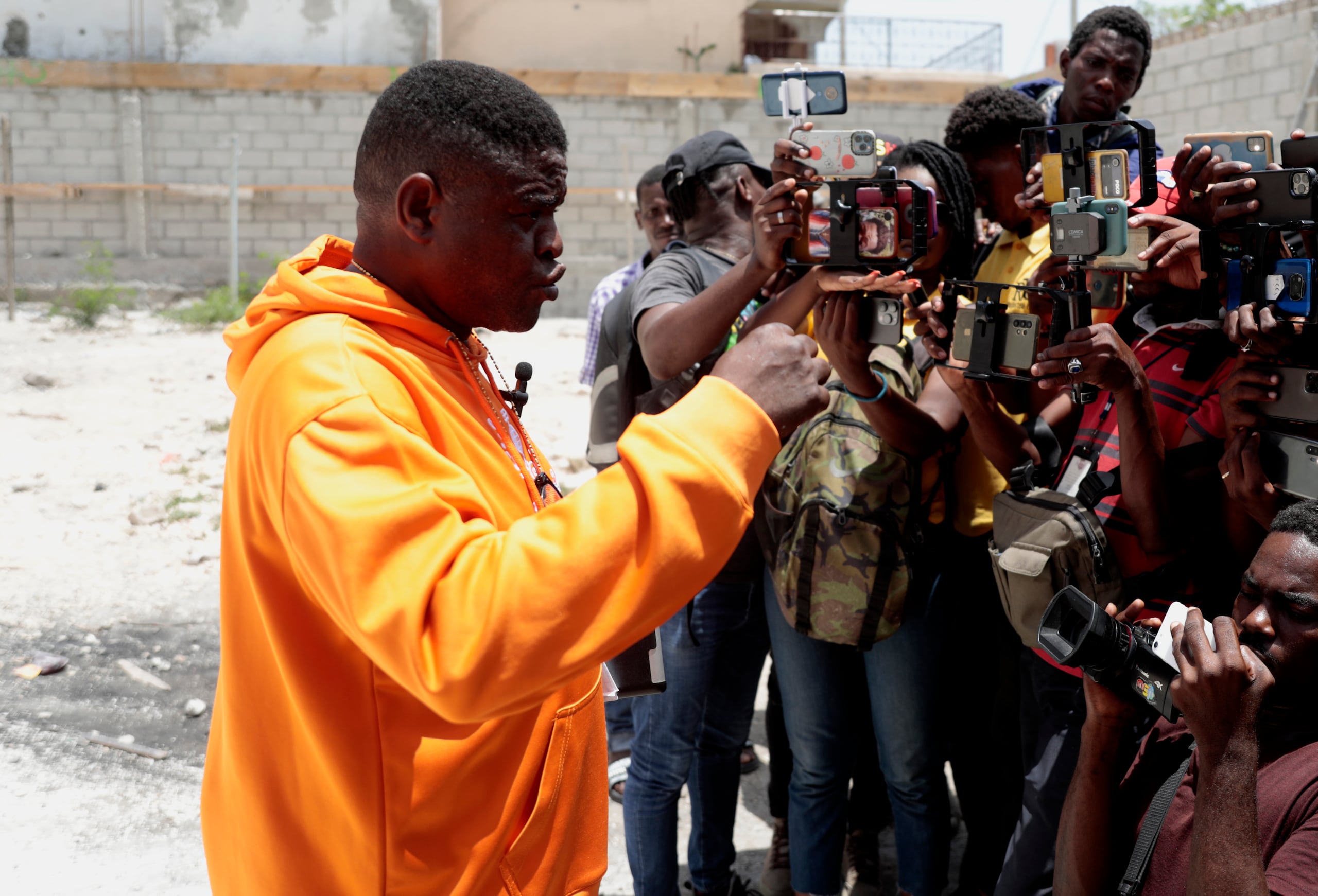 Jimmy Cherizier, the leader of the "G9 et Famille" gang, speaks to a gaggle of journalists in Delmas 6, a district of Port-au-Prince, Haiti, Wednesday, Aug. 16, 2023. Cherizier, an ex-police officer considered to be Haiti's most powerful gang leader, warns he will fight any international armed force deployed to the Caribbean country if it commits any abuses.(AP Photo/Odelyn Joseph)