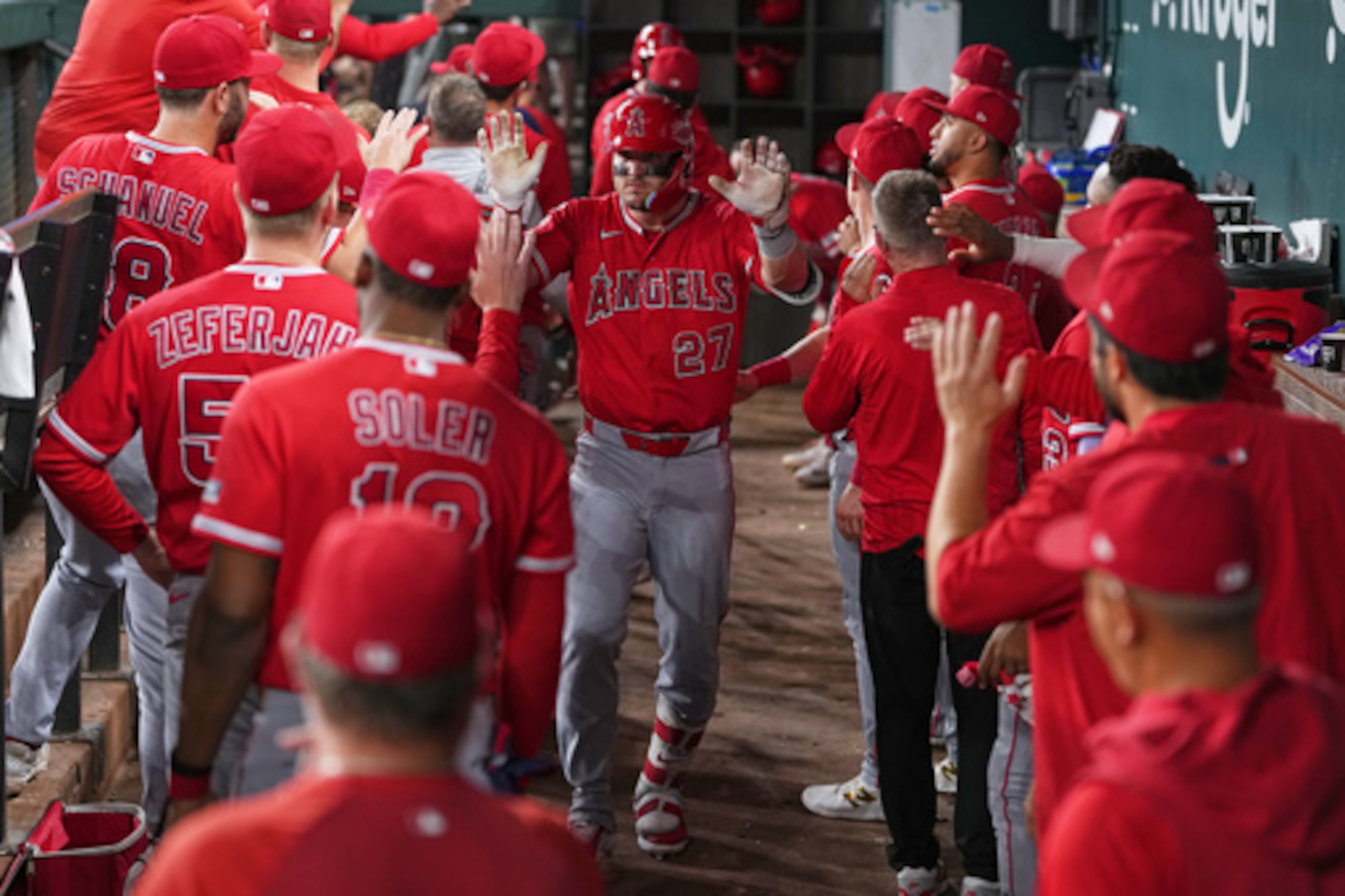 Mike Trout, bateador designado de los Angelinos de Los Ángeles, recibe felicitaciones en el banquillo tras batear un jonrón de dos carreras contra los Rangers de Texas durante la octava entrada del partido de béisbol de las Grandes Ligas celebrado el miércoles 8 de julio de 2026 en Arlington, Texas. (Foto AP/Julio Cortez)